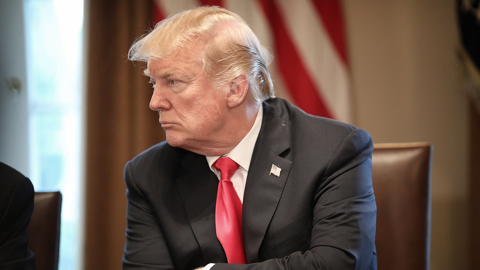 President Trump with his arms folded.