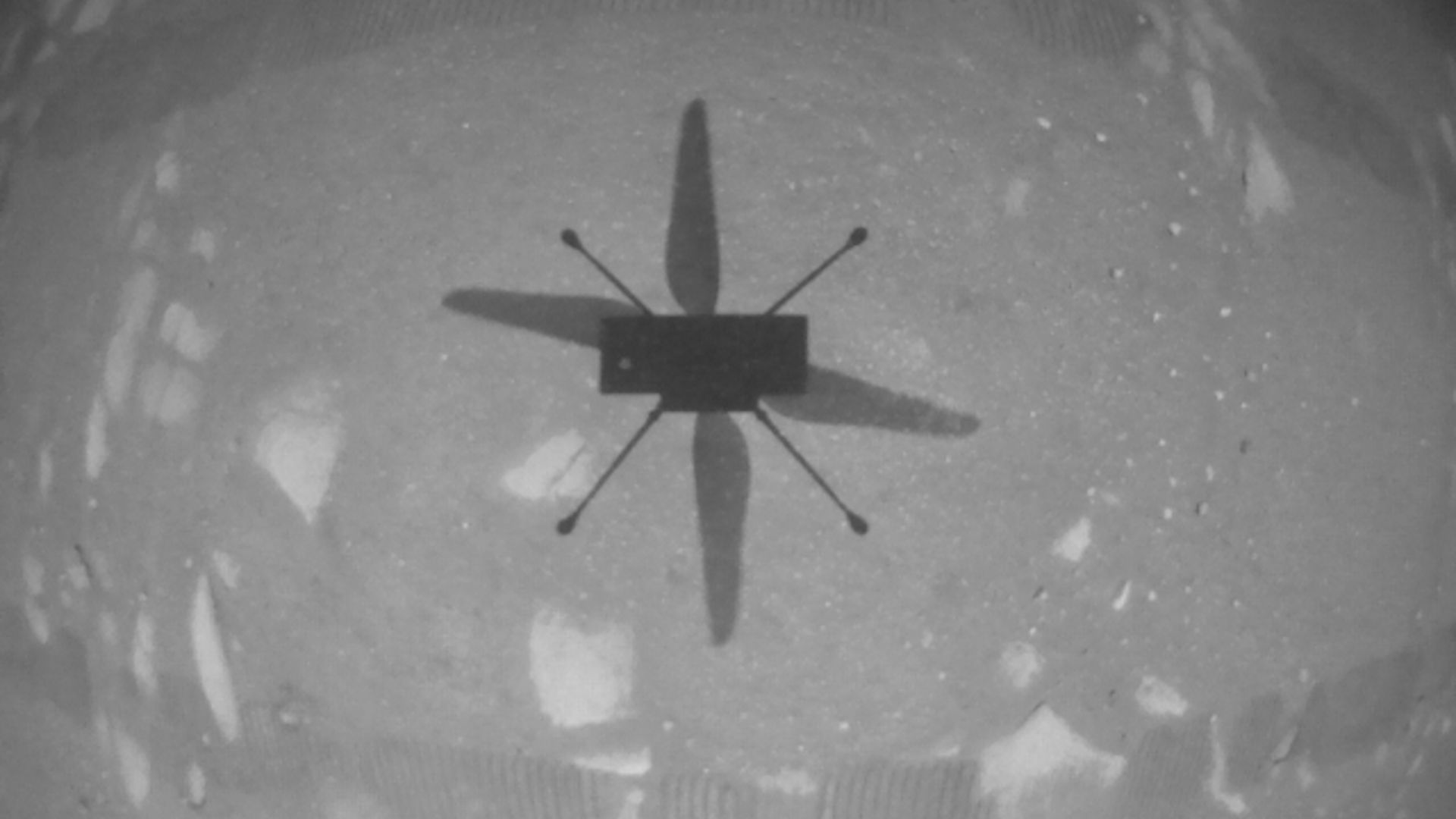 The shadow of the Ingenuity helicopter flying on Mars