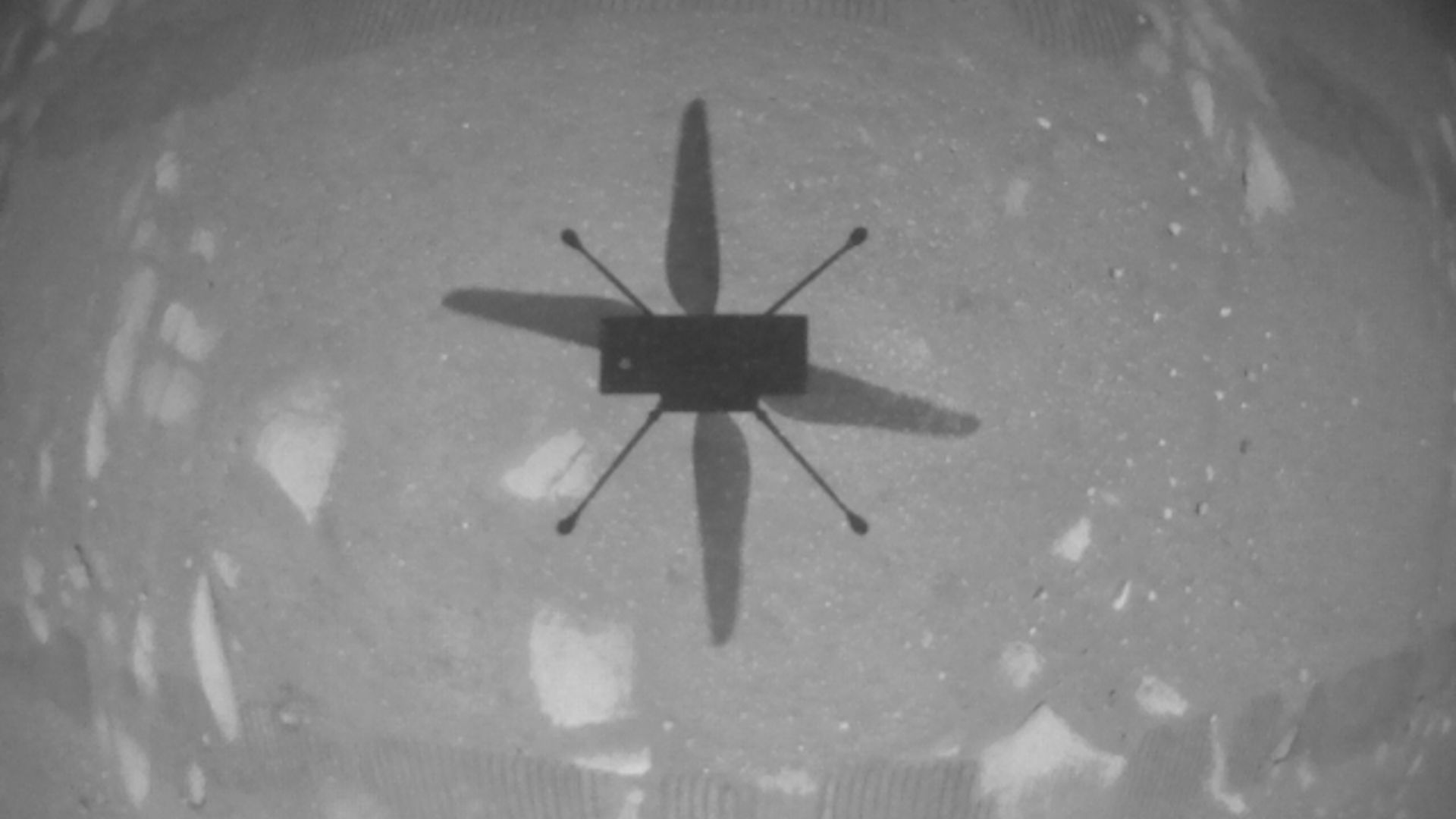 The shadow of the Ingenuity helicopter flying on Mars