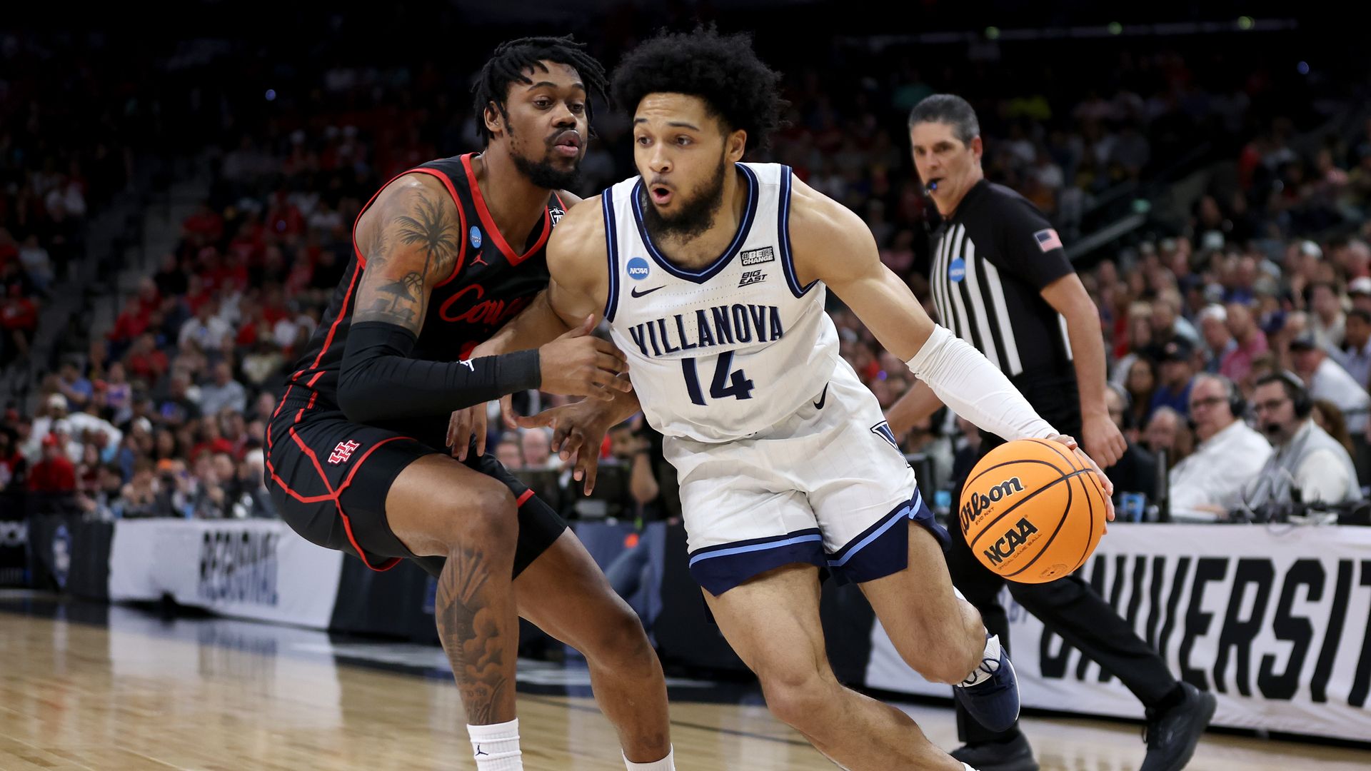A photo of Villanova's Caleb Daniels driving against J'Wan Roberts of the Houston Cougars during the NCAA Men's Basketball Tournament on March 26 in San Antonio, Texas.