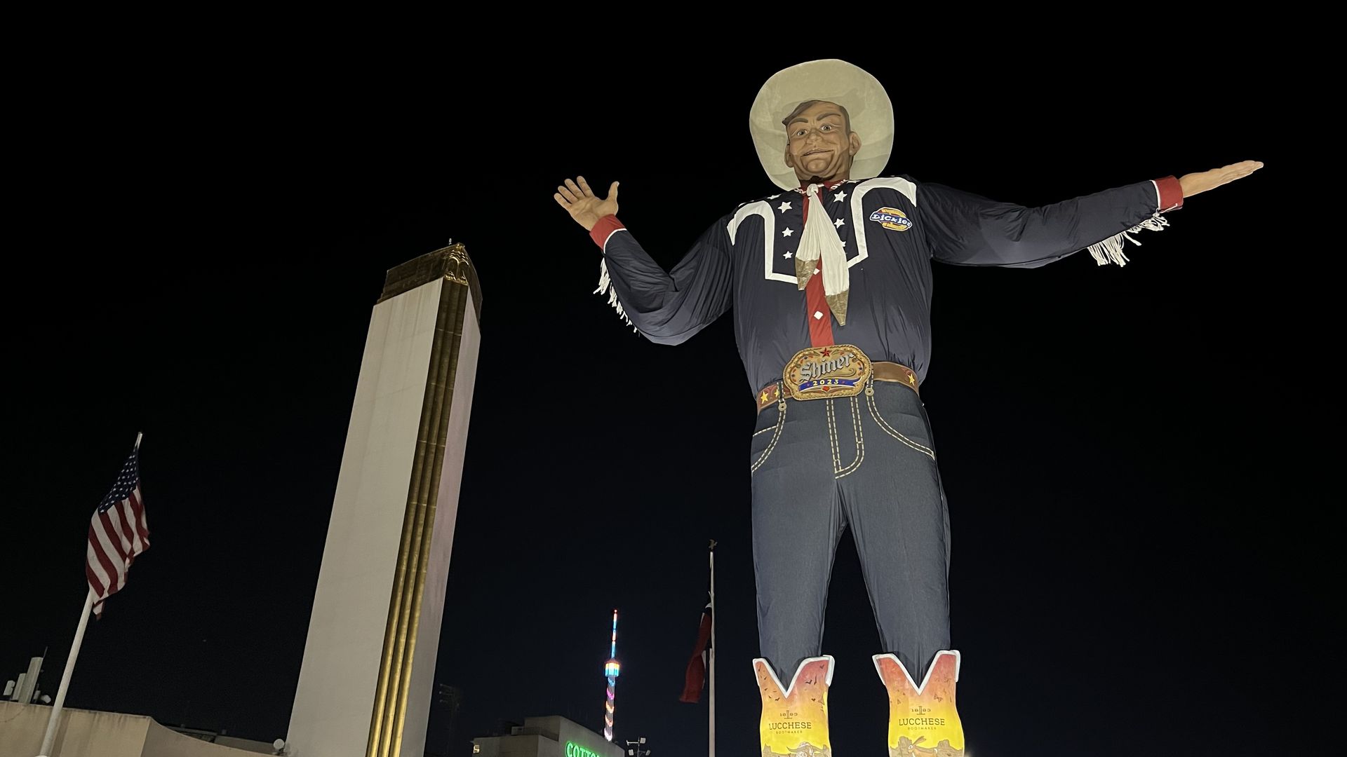 The giant Big Tex next to the Tower Building at the State Fair of Texas at night