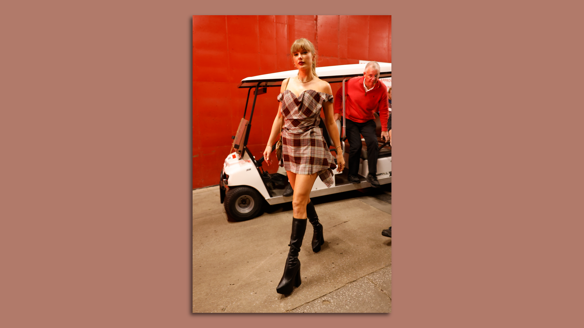 Taylor Swift walks away from a golf cart.