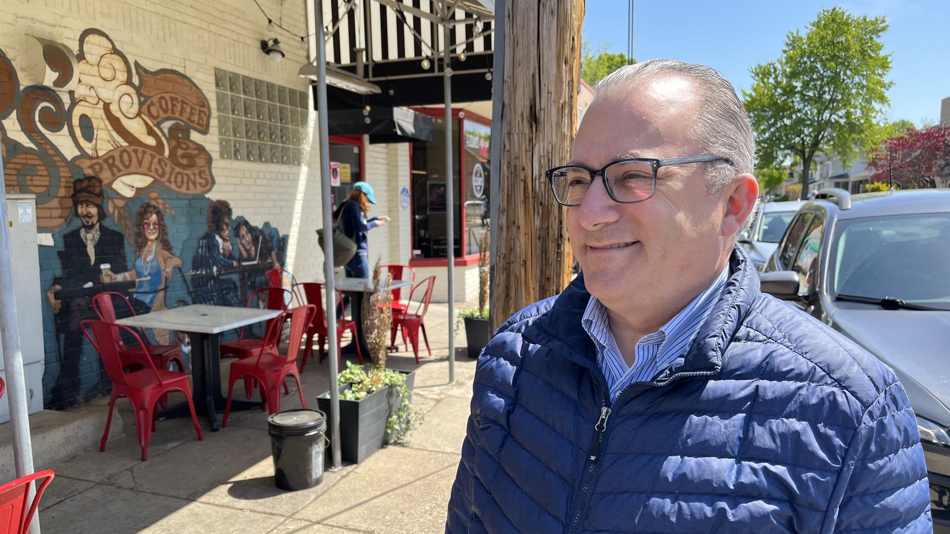 State sen. Adam Ebbin looks off the camera outside a cafe
