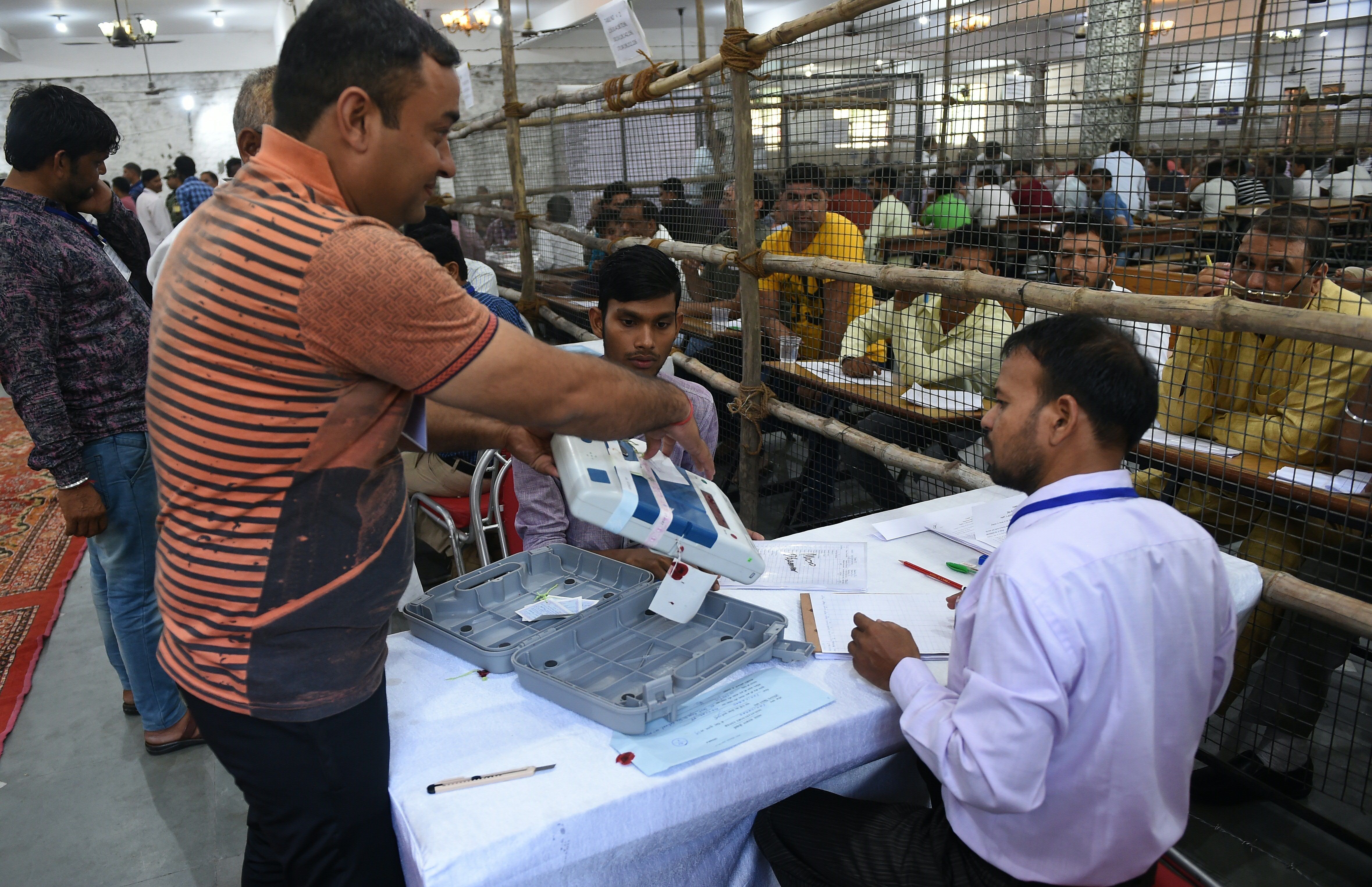 Indian election officials show an open Electronic Voting Machine (EVM) to counting agents at a counting centre in Faridabad in the northern Indian state of haryana on May 23, 2019.