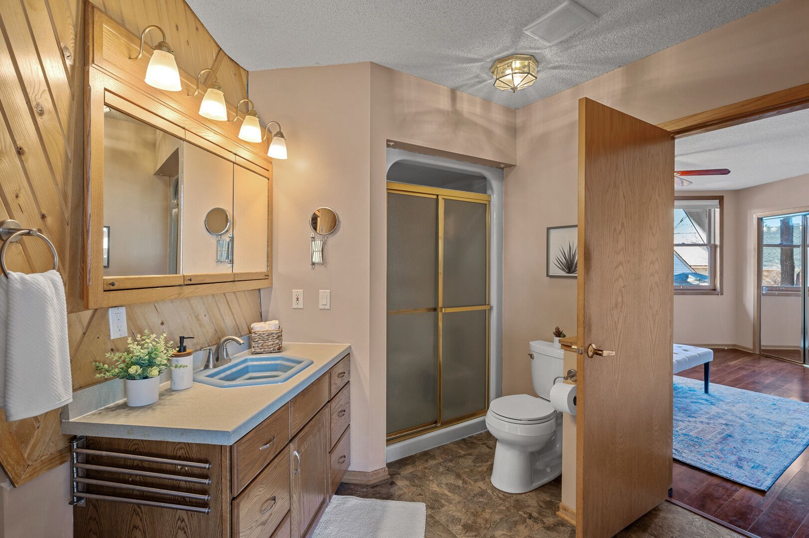 A bathroom with wood walls and tile floor.