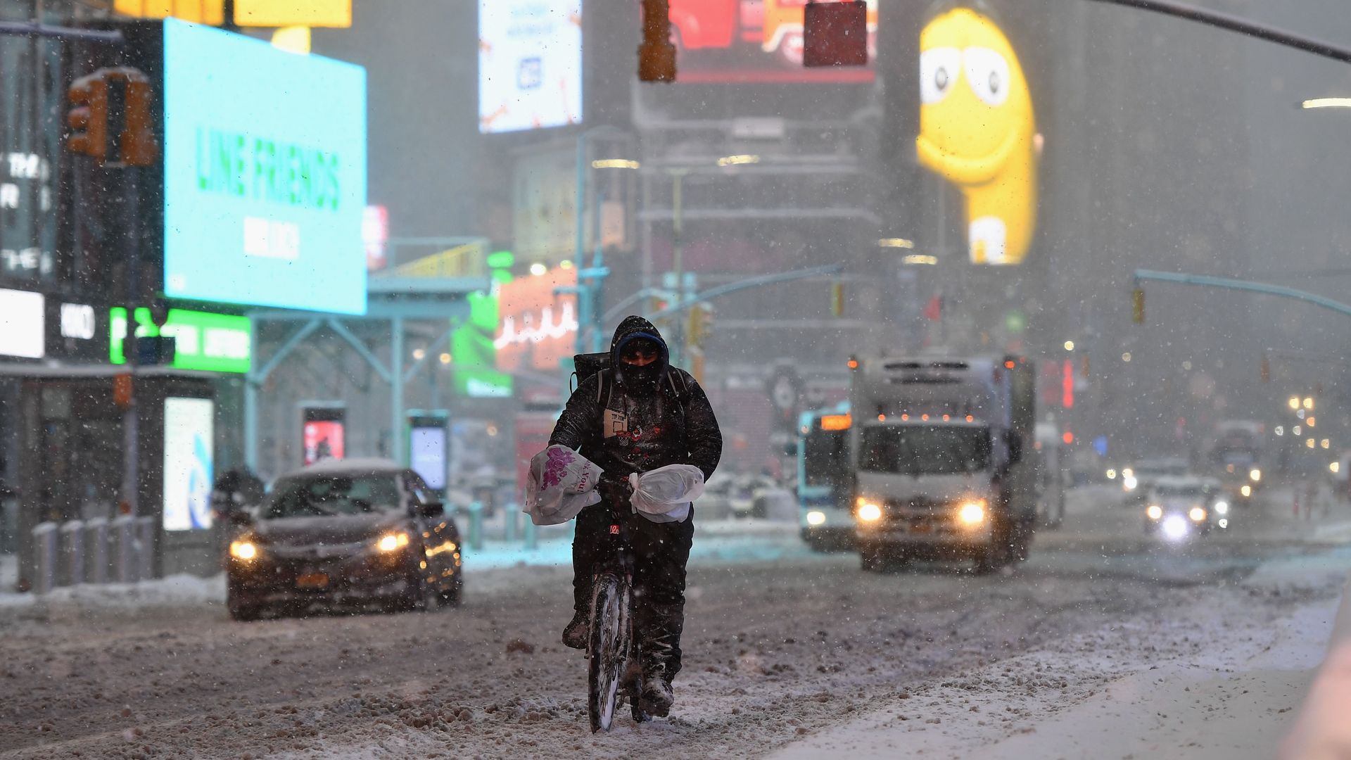 A person rides their bicycle in Times Square during a winter storm on February 1, 2021 in New York City.