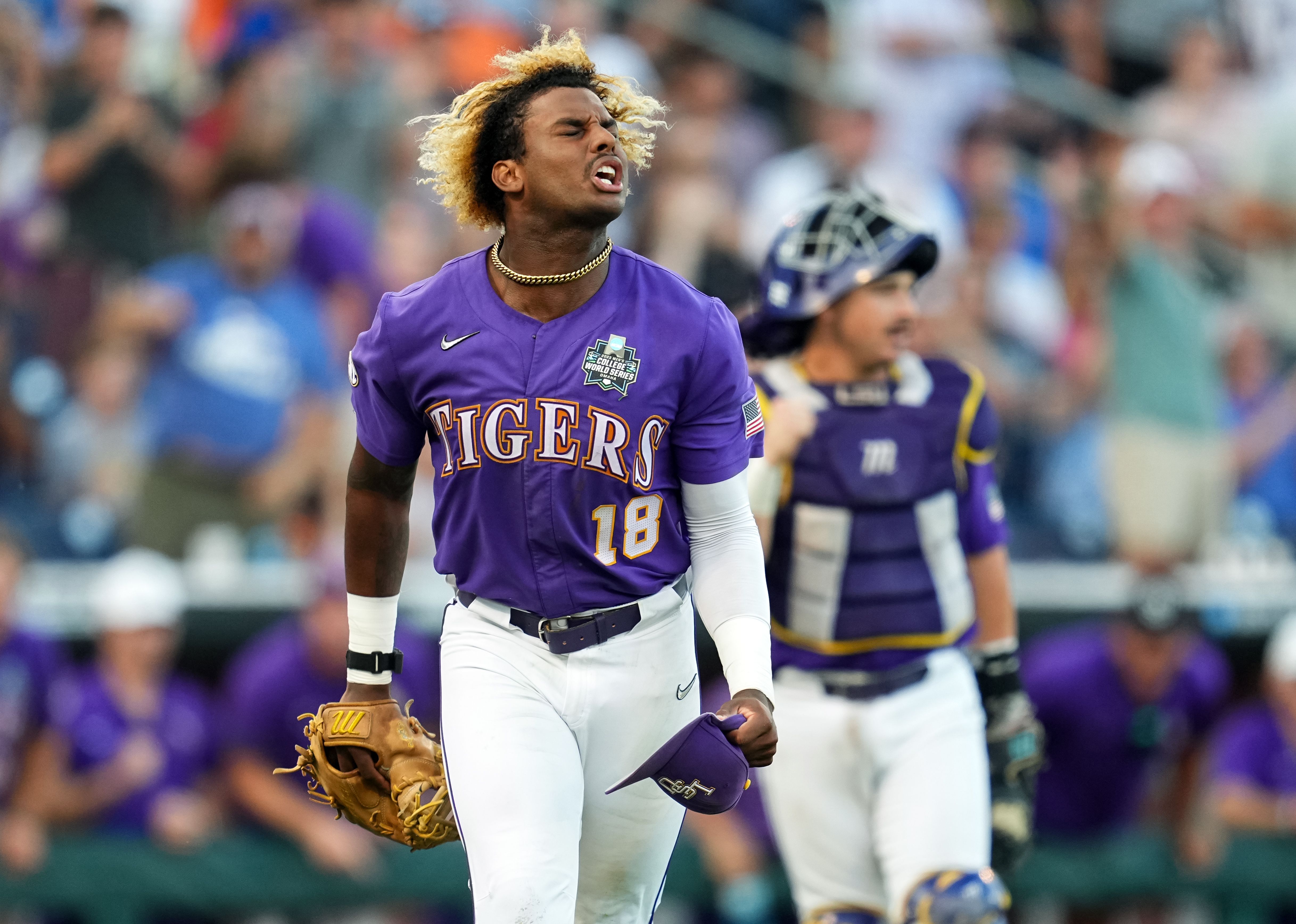 Louisiana State baseball player Tre Morgan, wearing a purple jersey, celebrates a good play in the college World Series