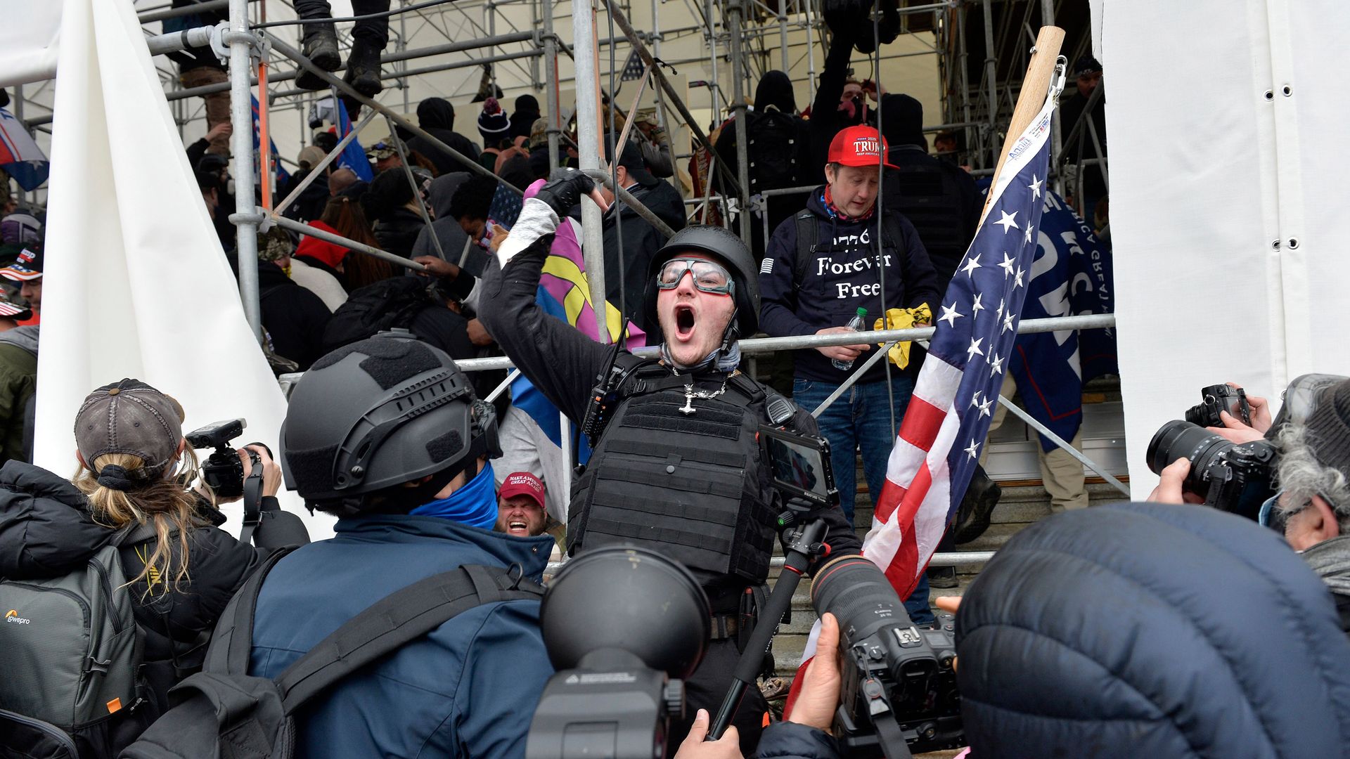 A man calls on people to raid the building as Trump supporters clash with police and security forces as they try to storm the US Capitol