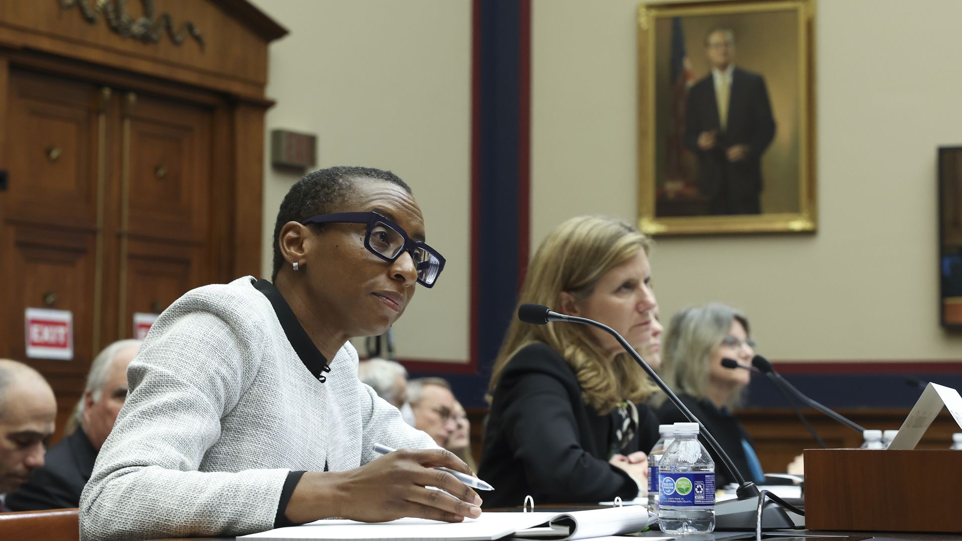 University presidents during congressional panel sitting at tables with microphones in front of them