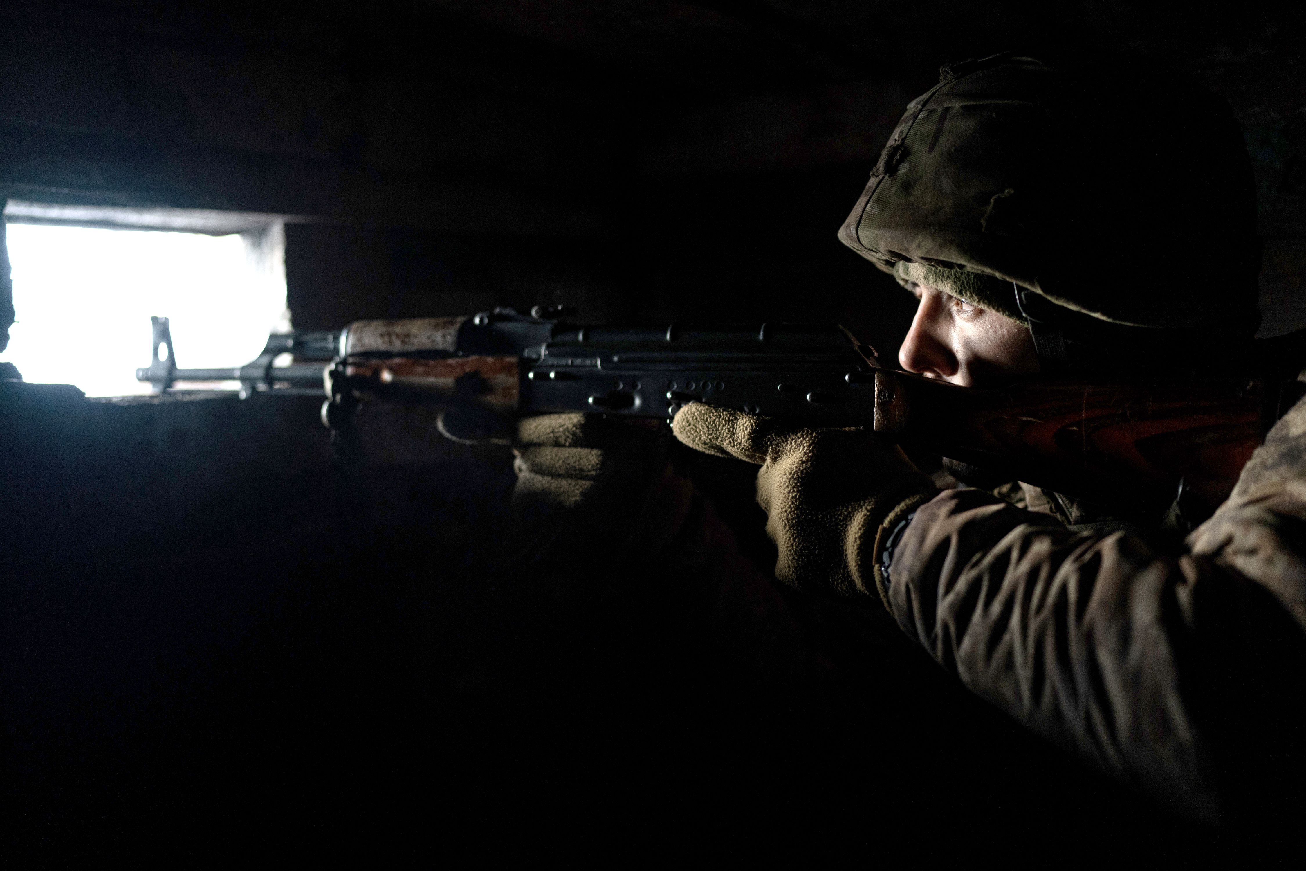  A Ukrainian soldier points his rifle from the frontline in Zolote, Ukraine on January 20.