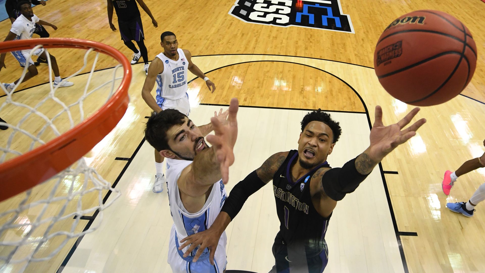 Two basketball players fight for a rebound at Nationwide Arena. 