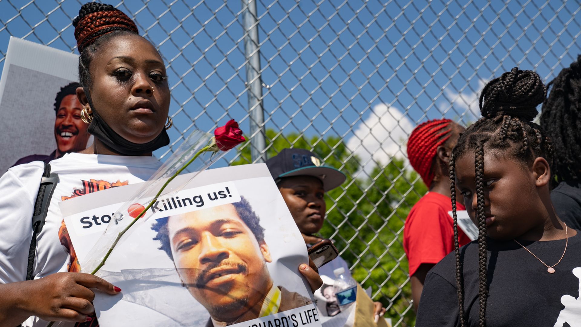 other Shenita Binns holds a sign with daughter Ysrael Binns on the anniversary of the killing of Rayshard Brooks to honor his life and to demand justice on June 12, 2021 in Atlanta, Georgia.