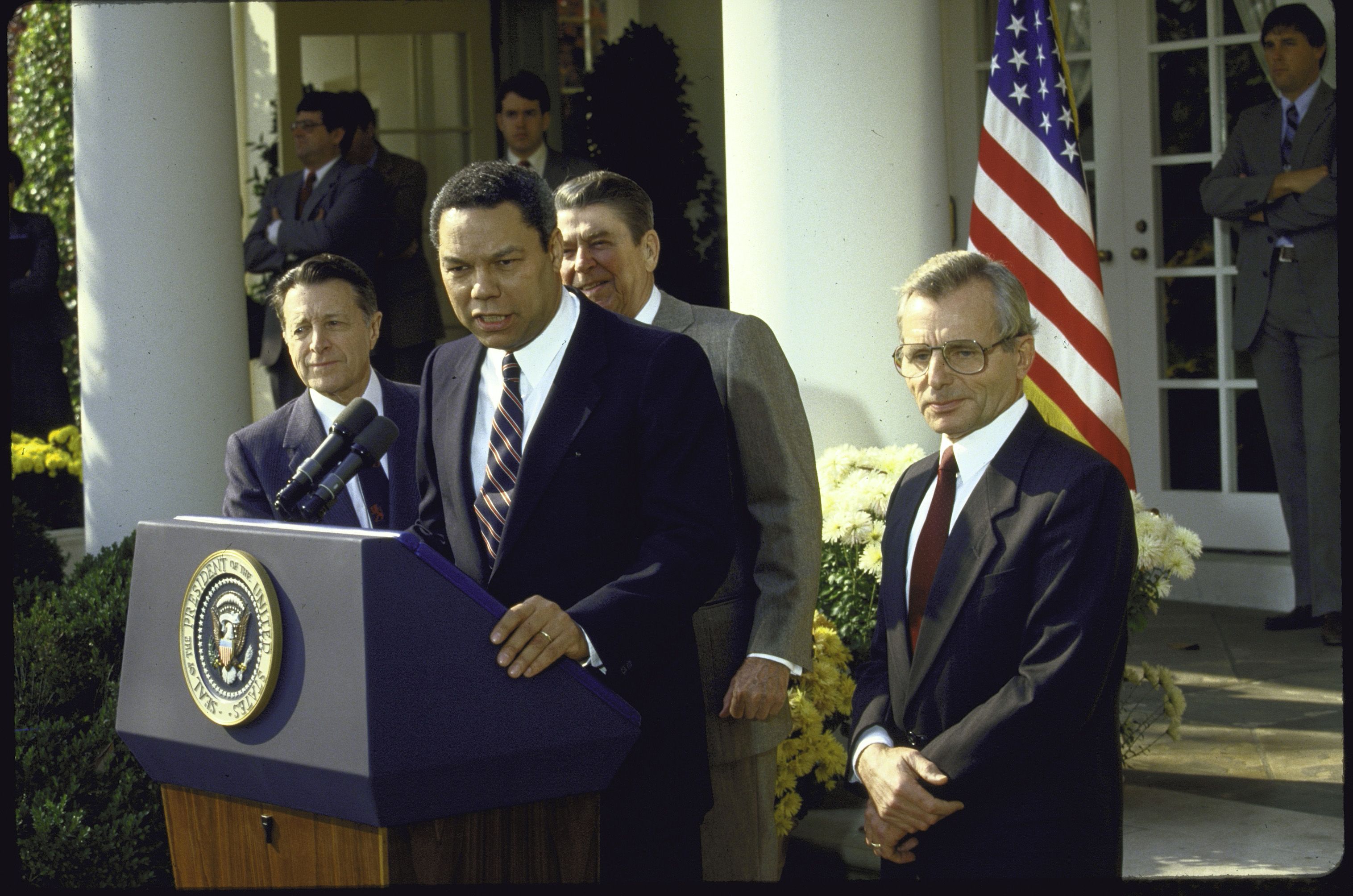 Colin Powell speaking at the Rose Garden with former President Ronald Reagan.