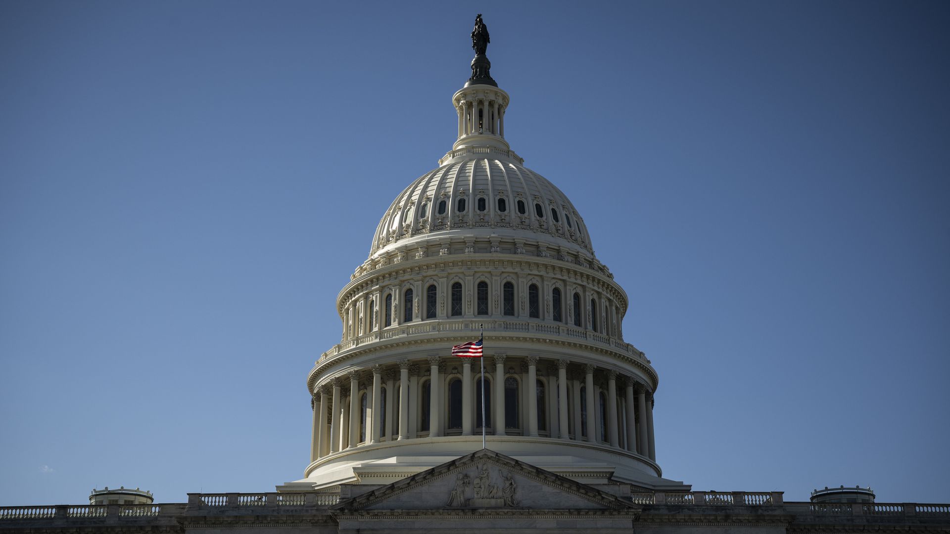 The dome of the United States Capitol building, with a blue sky in the background. 