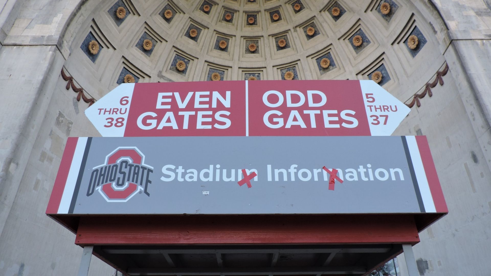 An information booth in front of Ohio Stadium has red tape in the shape of an X over the Ms in "stadium information"