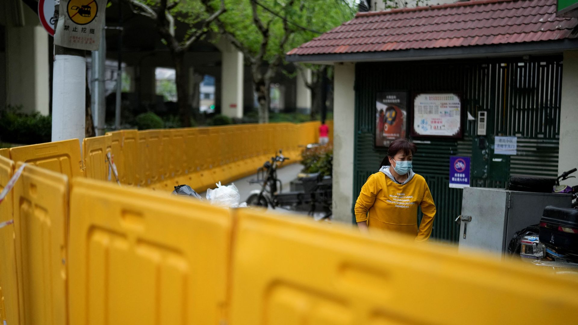 A Shanghai resident, behind barriers sealing off an area under COVID lockdown.