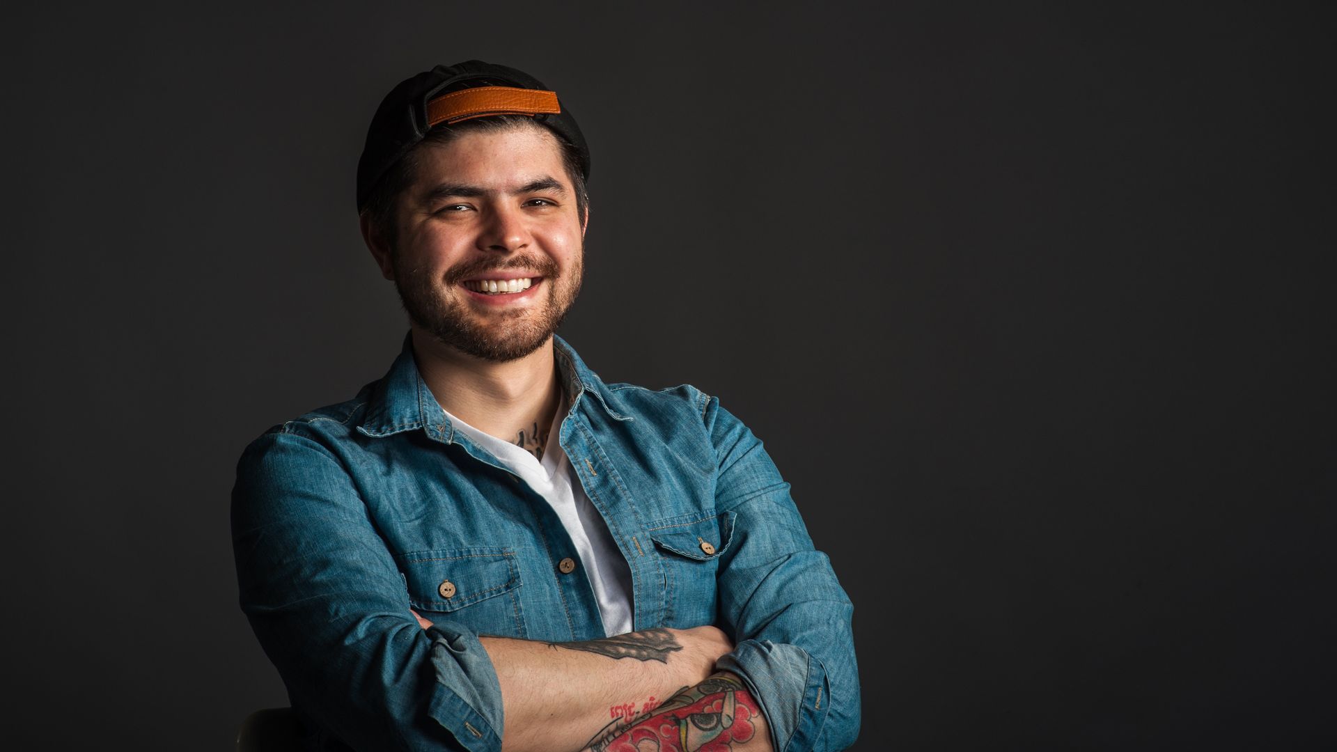 Erik Bruner-Yang in a denim shirt and backward hat