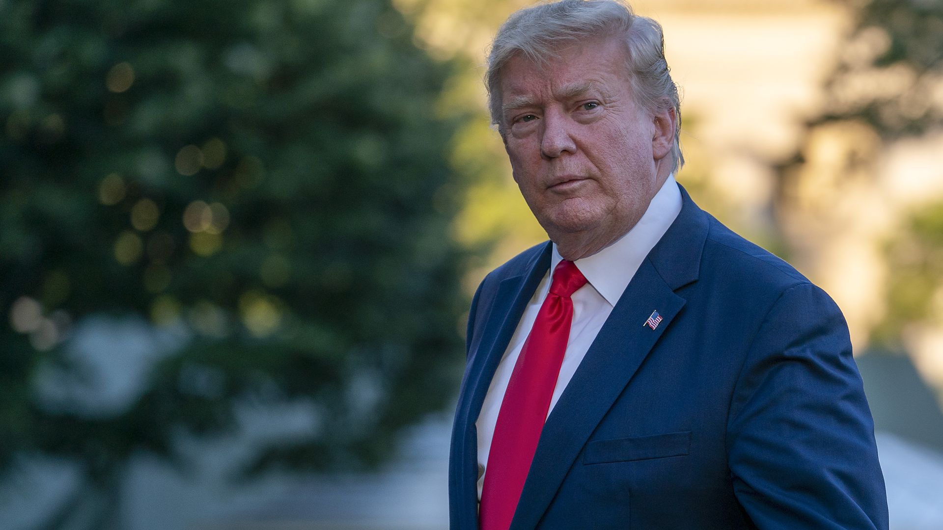 trump walking and looking to his left. 