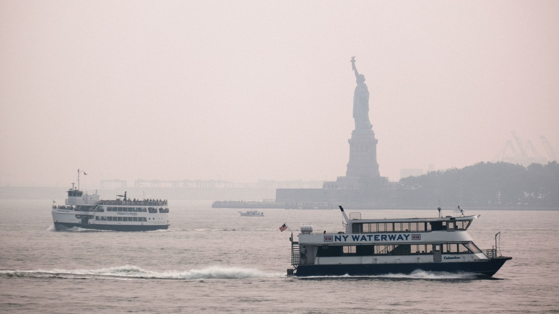 The Statue of Liberty sits behind a cloud of haze on July 20, 2021 in New York City. 