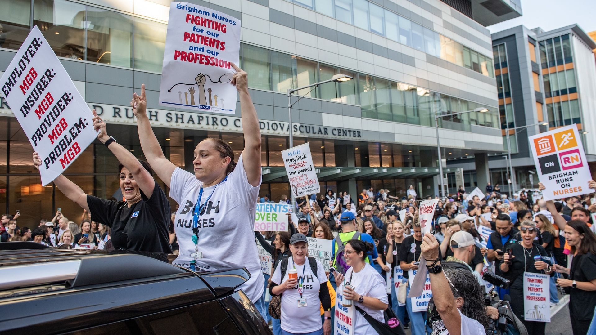 Hundreds of nursing staff hold signs in Boston's Longwood Medical Area on Wednesday, July, 8, as part of their one-day strike. Some 4,000 nurses are on strike as they negotiating a new contract with Mass General Brigham.
