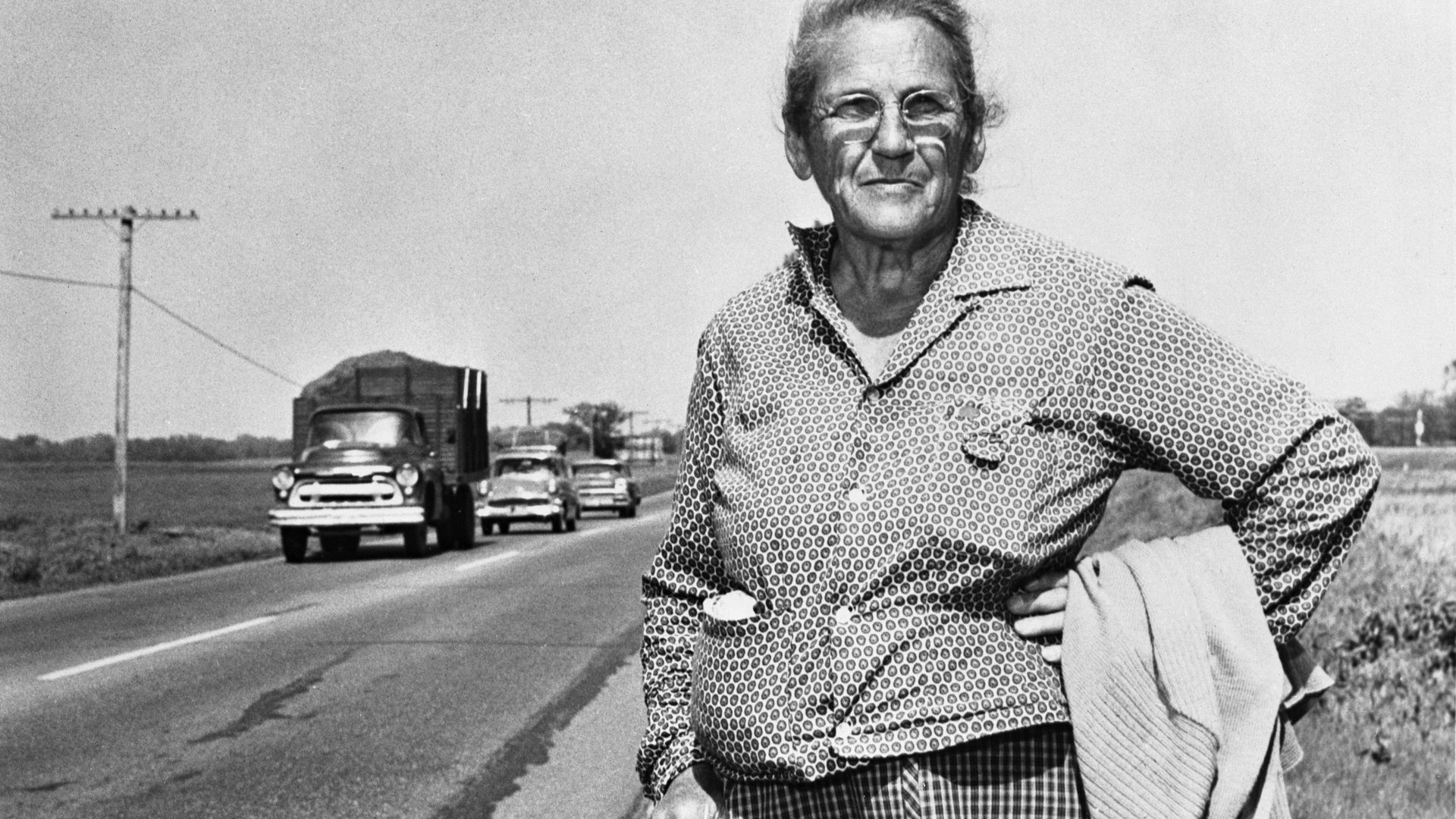Emma Gatewood, a 71-year-old hiker, is pictured on the side of the road in a historical photograph.