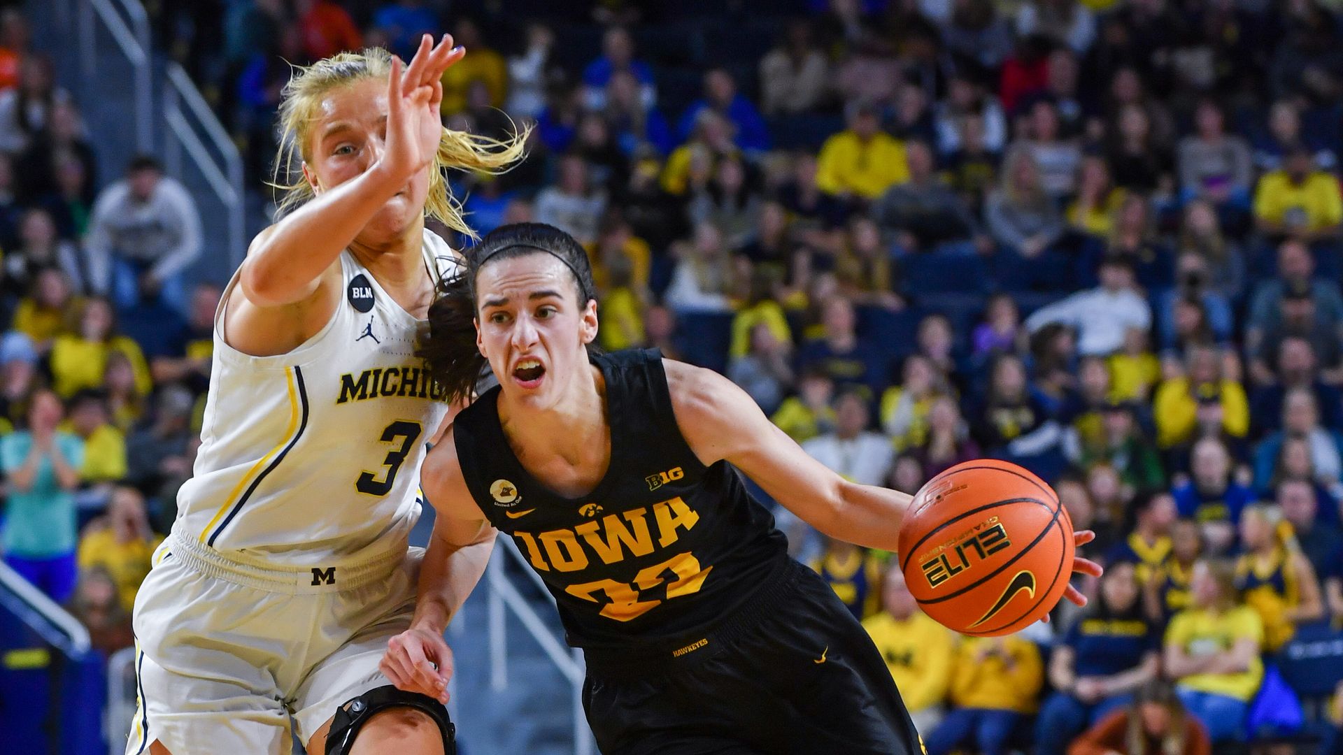 Caitlin Clark #22 of the Iowa Hawkeyes dribbles the ball to the basket against Maddie Nolan #3 of the Michigan Wolverines during the second half of a college basketball game at Crisler Arena on January 07, 2023 in Ann Arbor, Michigan. (Photo by Aaron J. Thornton/Getty Images)