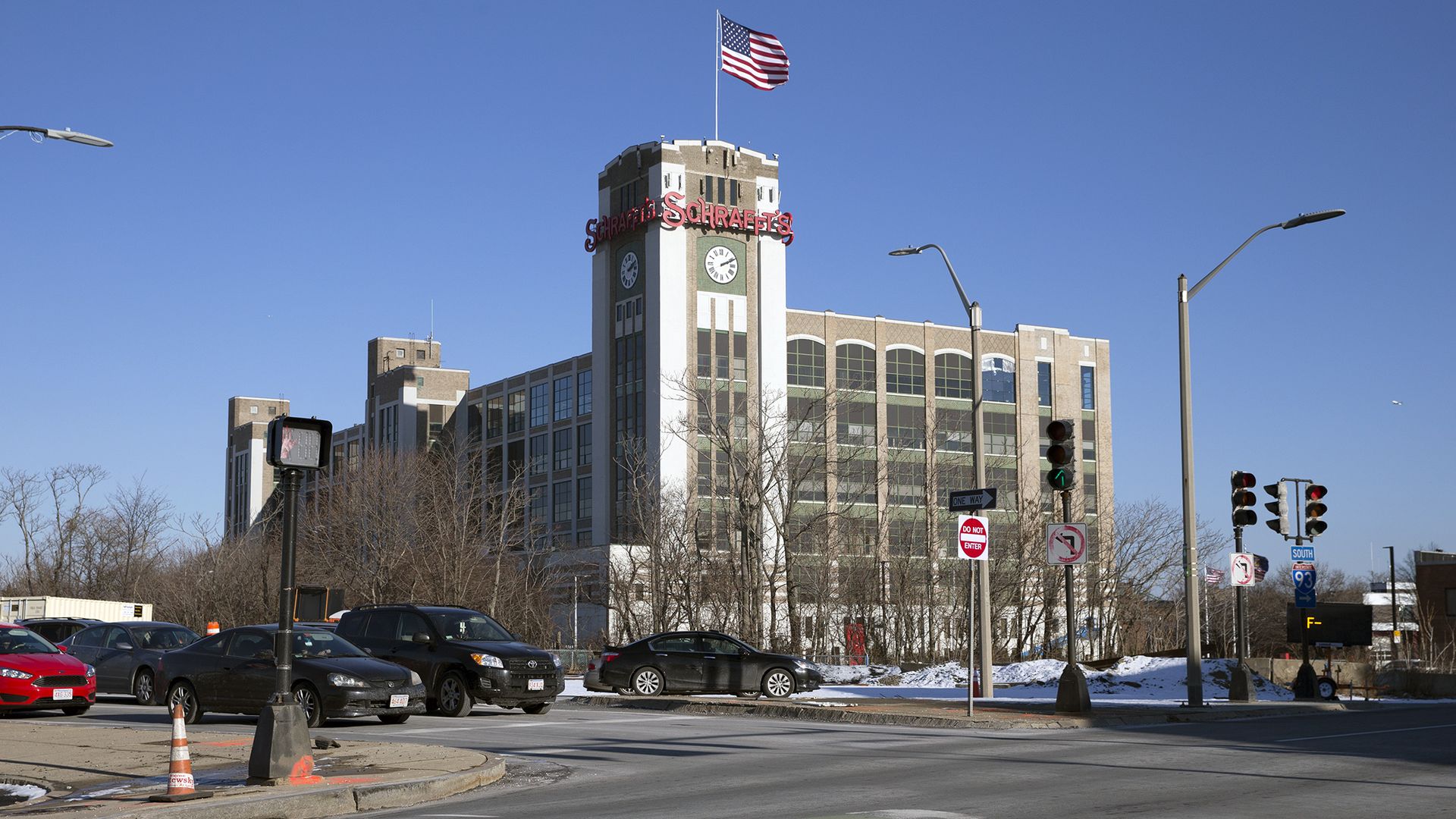 A 2018 photo showing cars in the traffic circle in Sullivan Square, with the former Schrafft's candy factory building in the background.