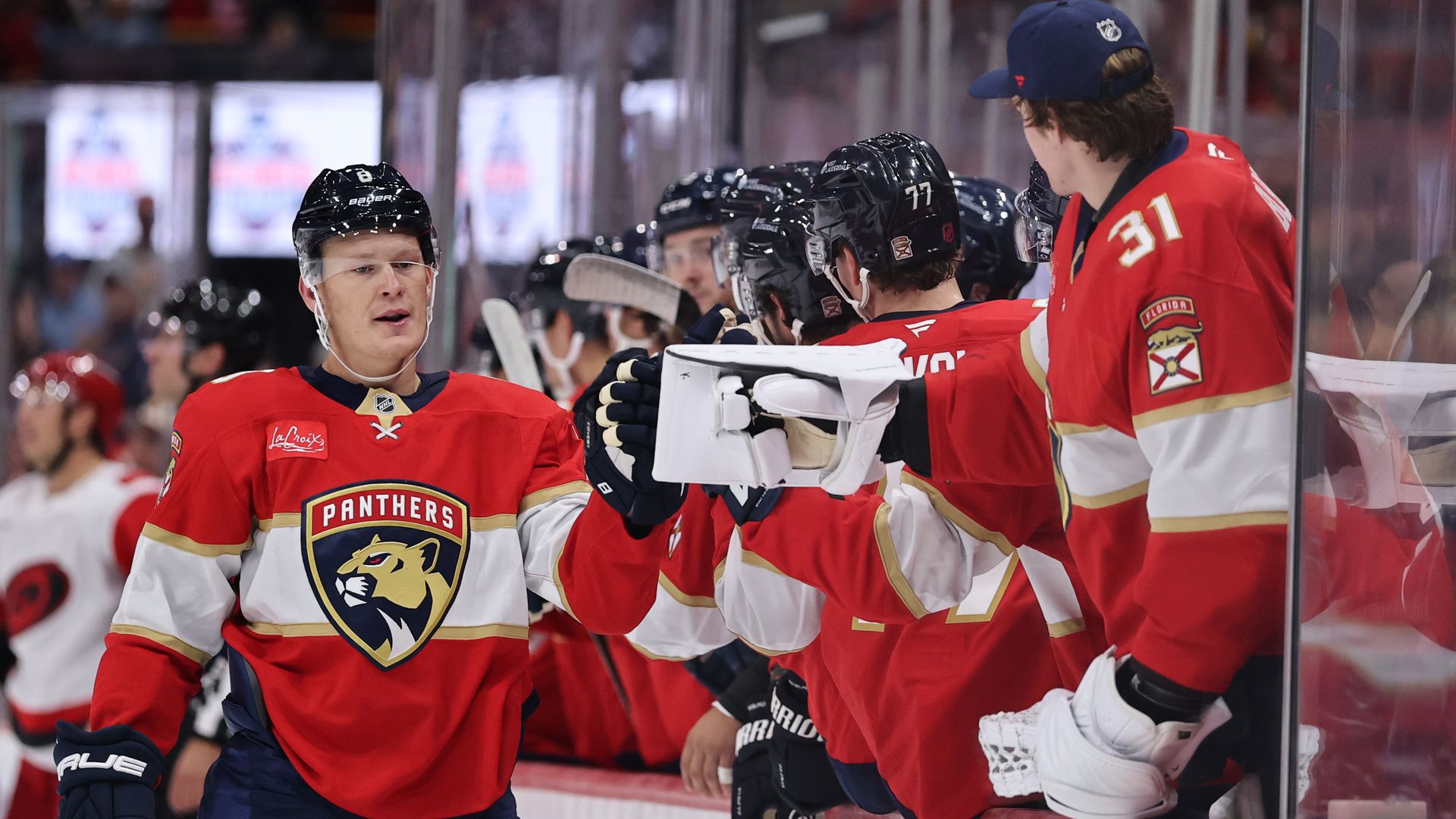 Brady Tkachuk Florida Panthers high fives teammates after scoring against the Carolina Hurricanes during the first period at Amerant Bank Arena.