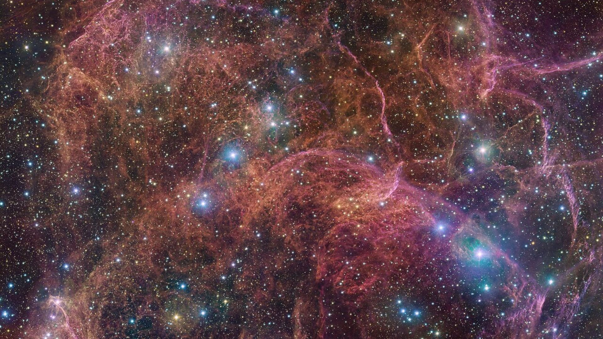 A supernova remnant shining in red with blue stars dotting the background