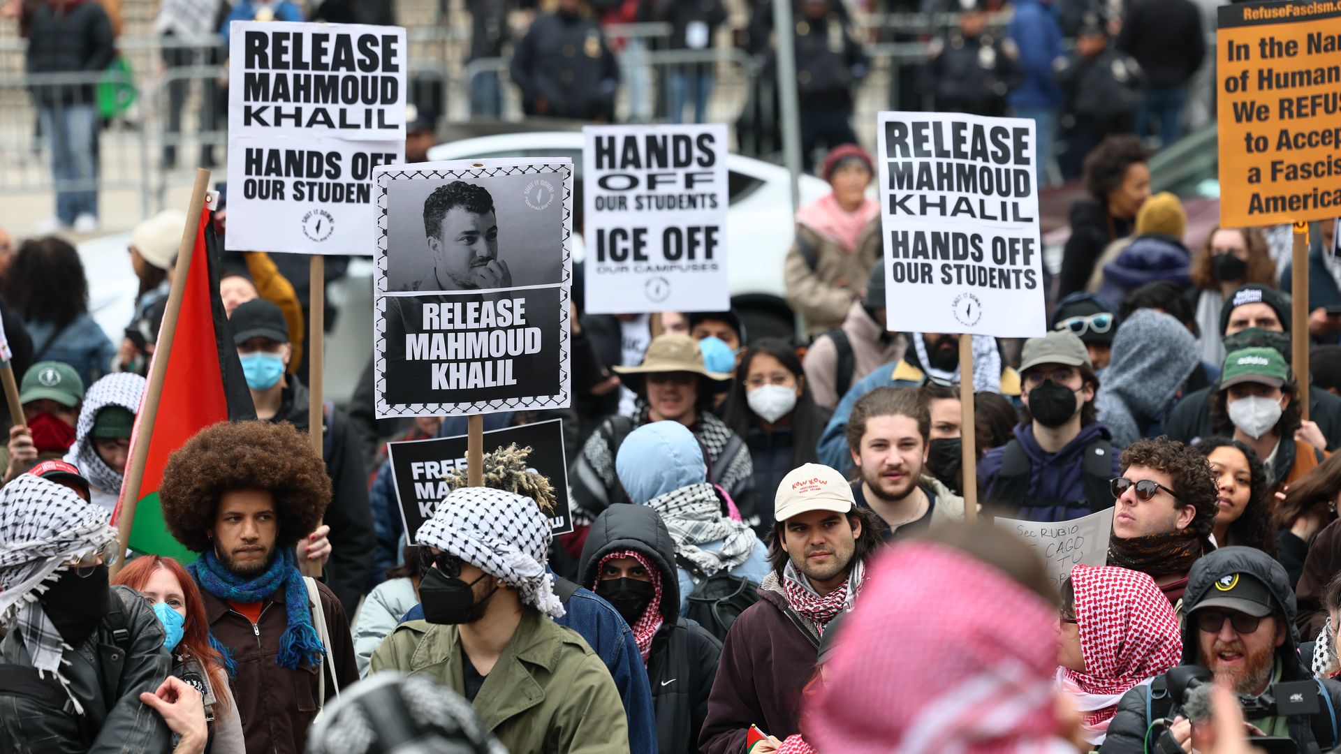 A crowd of protesters hold signs calling for the release of Mahmoud Khalil.