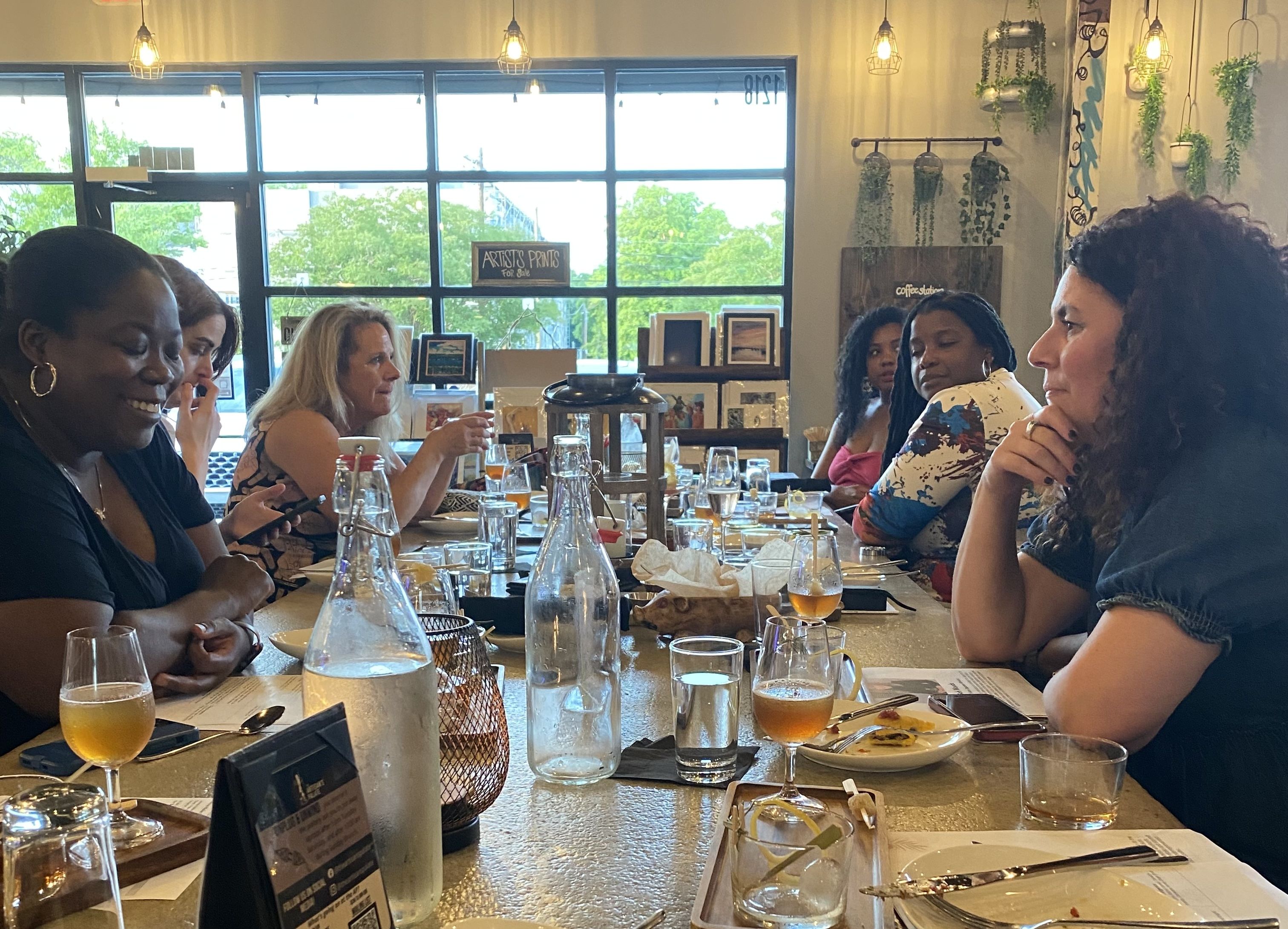six women chatting at the dinner table
