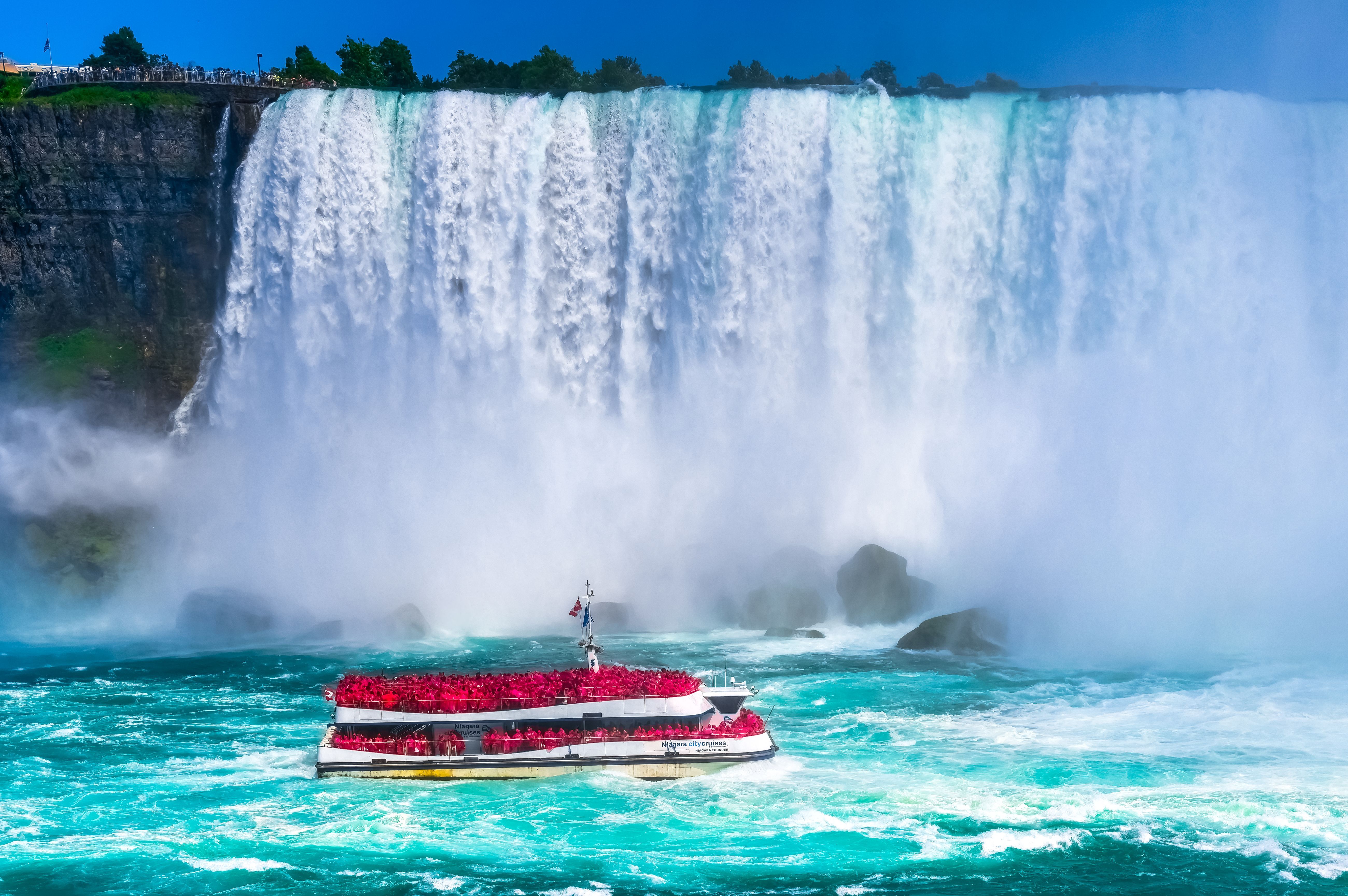 Niagara Falls, Ontario, Canada, Tour boat or small boats carrying passengers in the Niagara River. The ride is a tourist attraction. 
