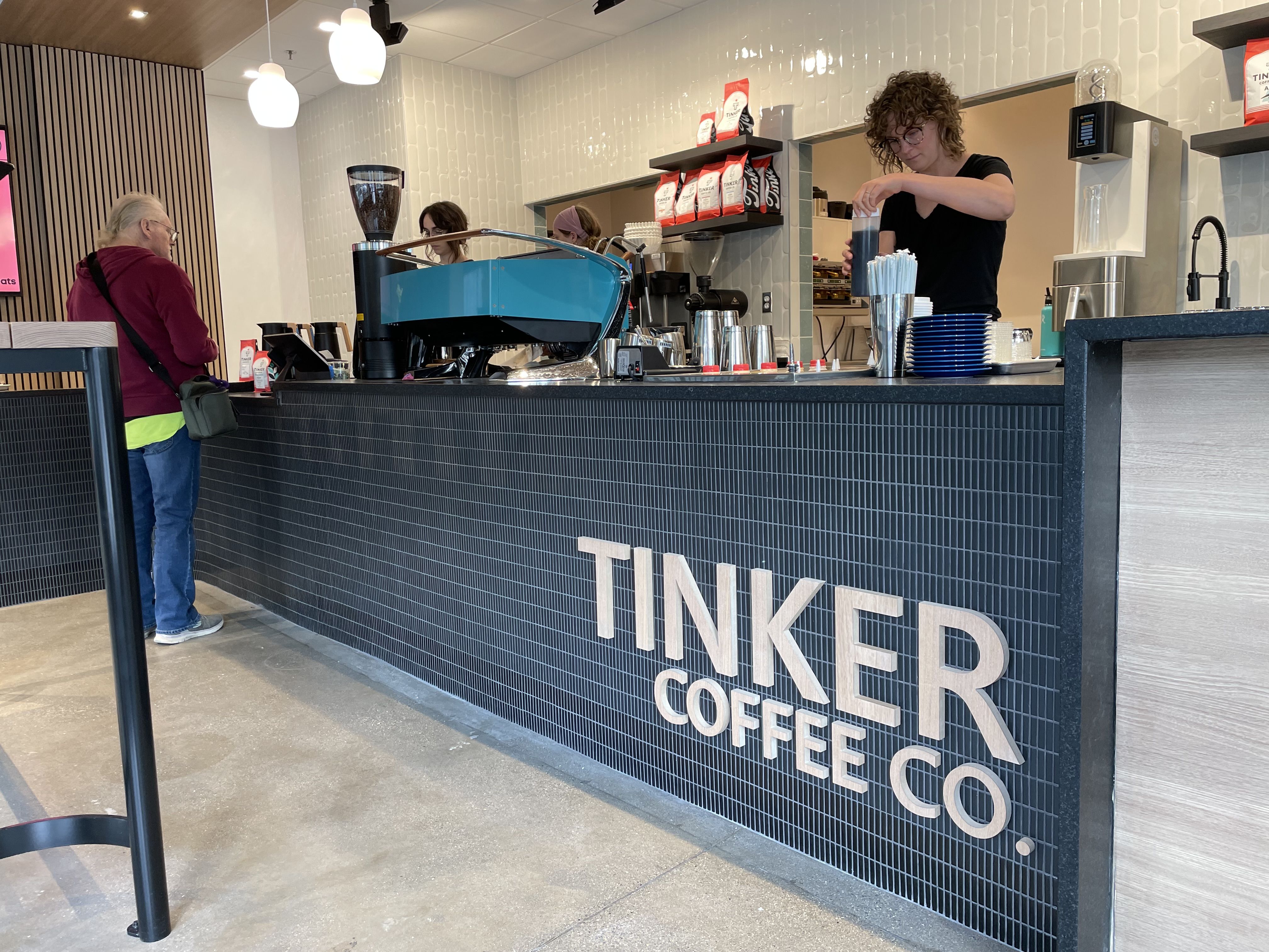 Baristas prepare drinks behind the counter inside the Tinker Coffee shop in downtown Indianapolis.