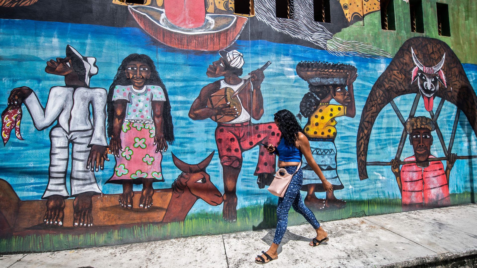 A woman, member of the Afro-Mexican community, walks past the Afro-Mexican musseum, in Cuajinicuilapa, Guerrero state, Mexico, on September 10, 2020.