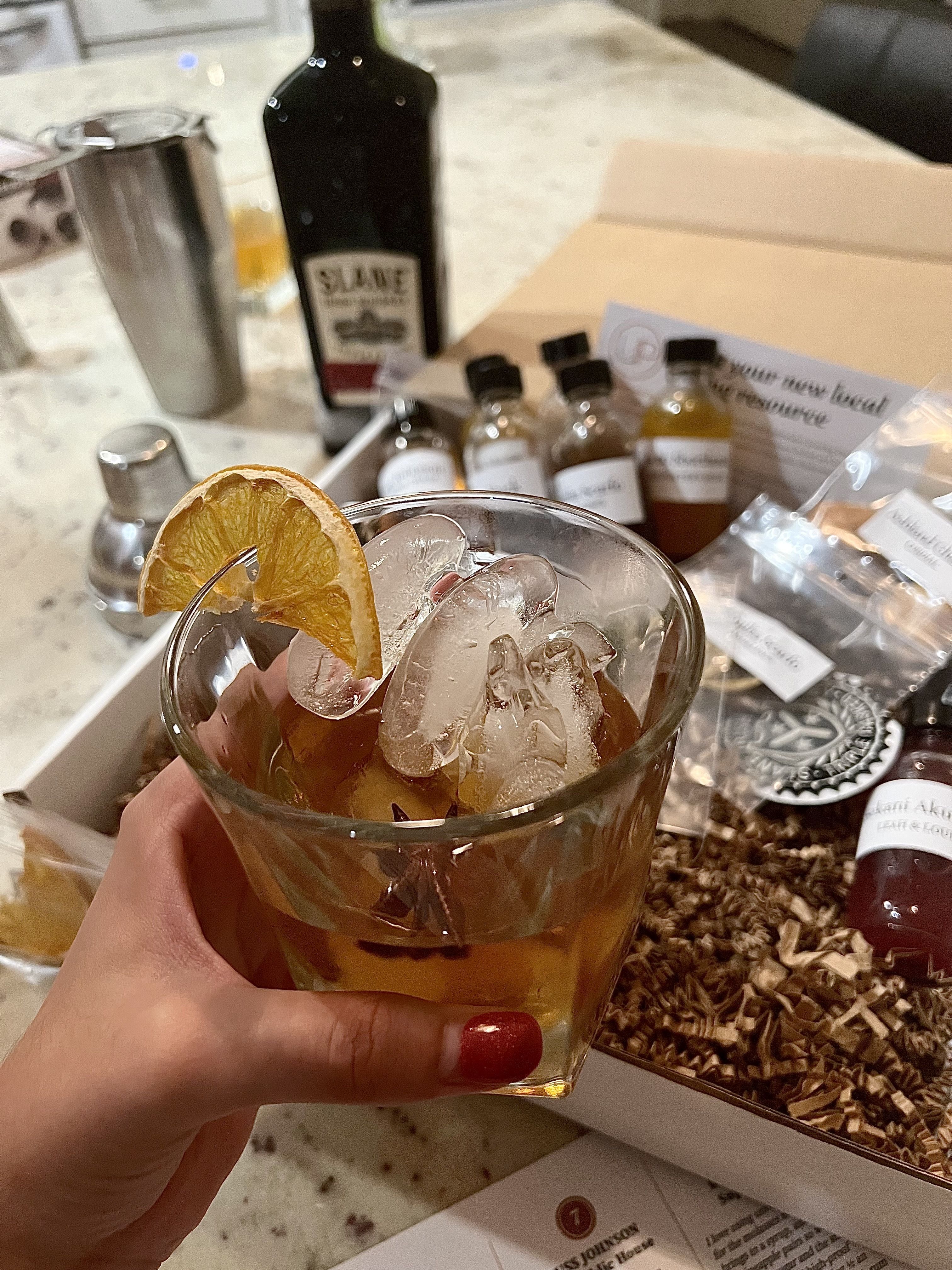 hand holding whiskey drink