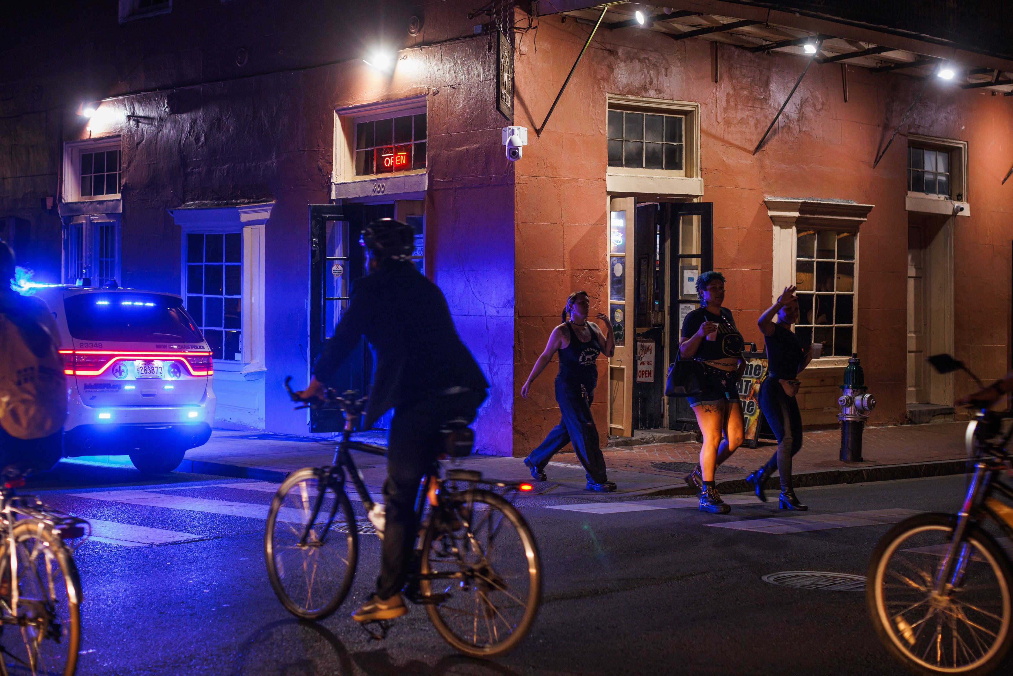 Image shows people riding bikes in the dark.
