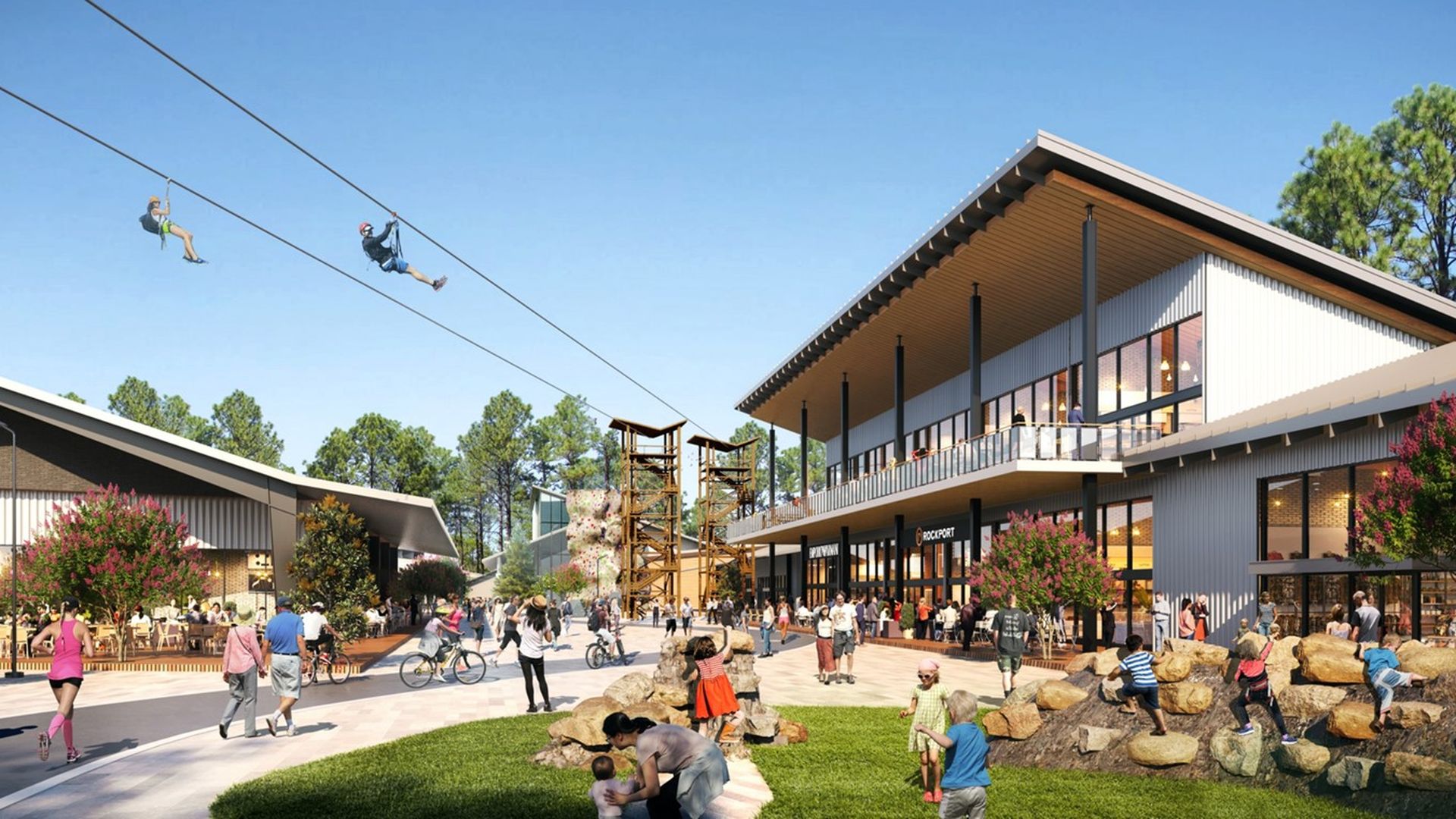 A conceptual rendering of an outdoor recreational area with zip lines, climbing structures, people walking, biking, and kids playing on rocks near modern buildings with patios and trees under a clear blue sky.