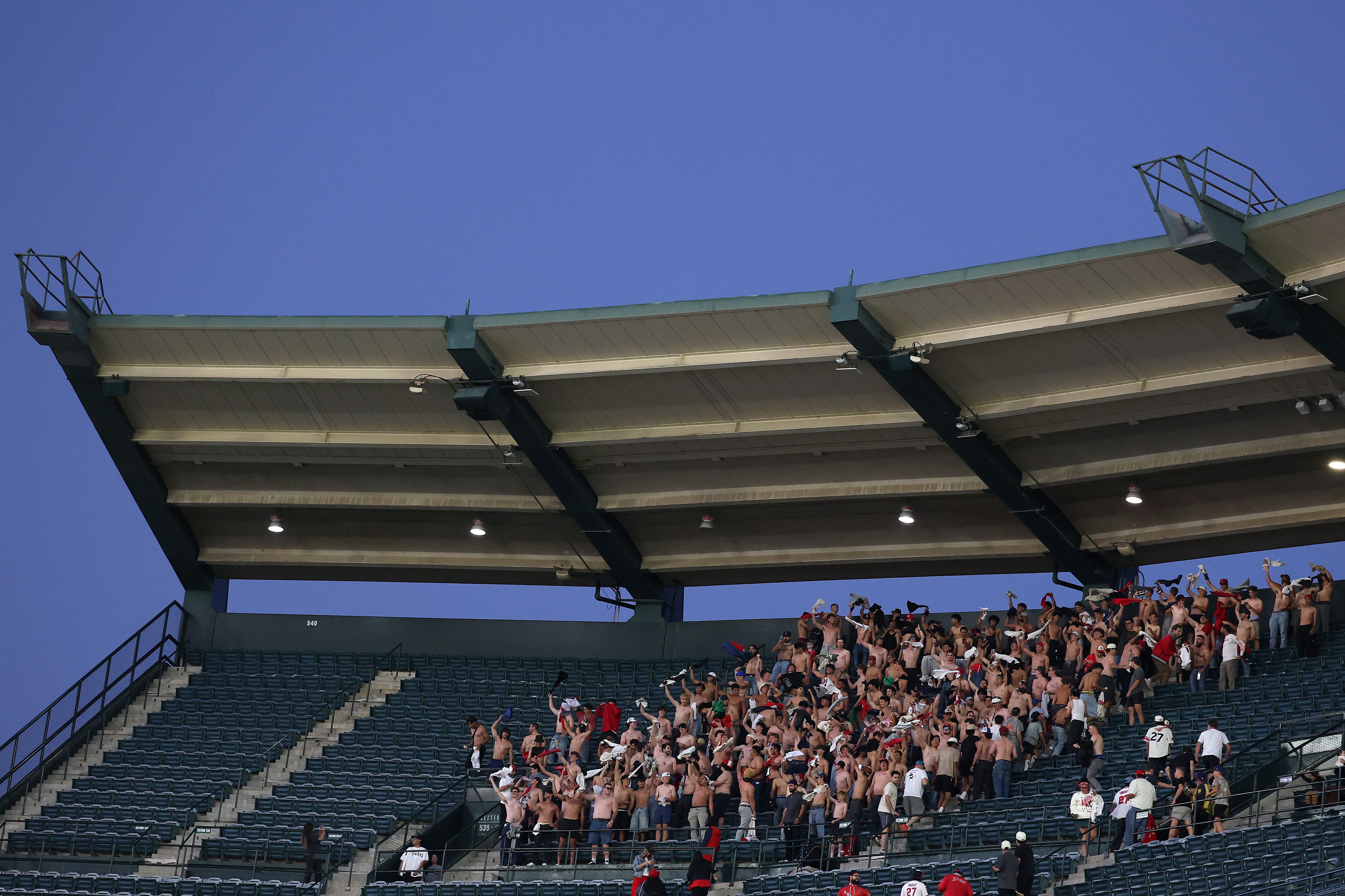Fans wave their shirts at Angel Stadium of Anaheim on Thursday. Photo: Luke Hales/Getty Images