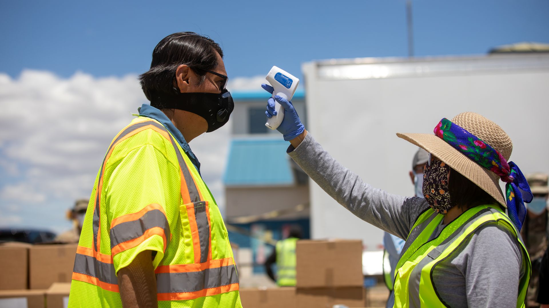 Picture of a person taking someone else's temperature in new mexico