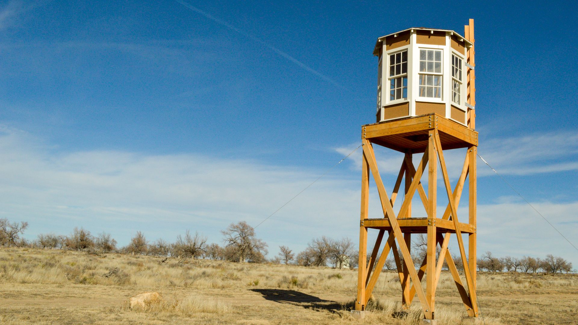 Photo of a mounted guardhouse overlooking dry land against a blue sky