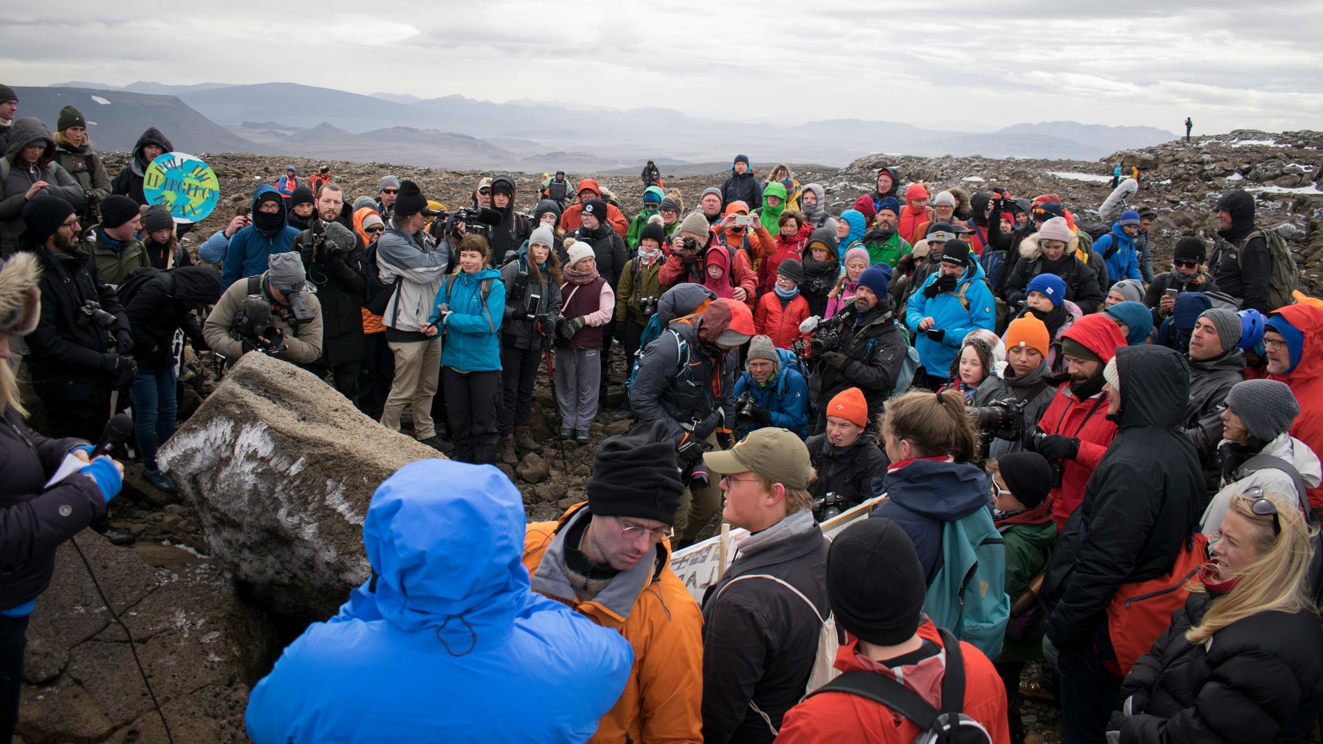 People gathering around a makeshift memorial for the glacier. Photo: JEREMIE RICHARD/AFP/Getty Images