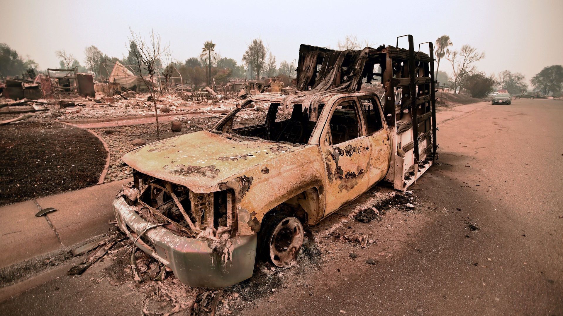 A destroyed truck is seen among the ruins of a burned neighborhood after the Carr fire passed through the area of Lake Keswick Estates near Redding, California on July 28, 2018.