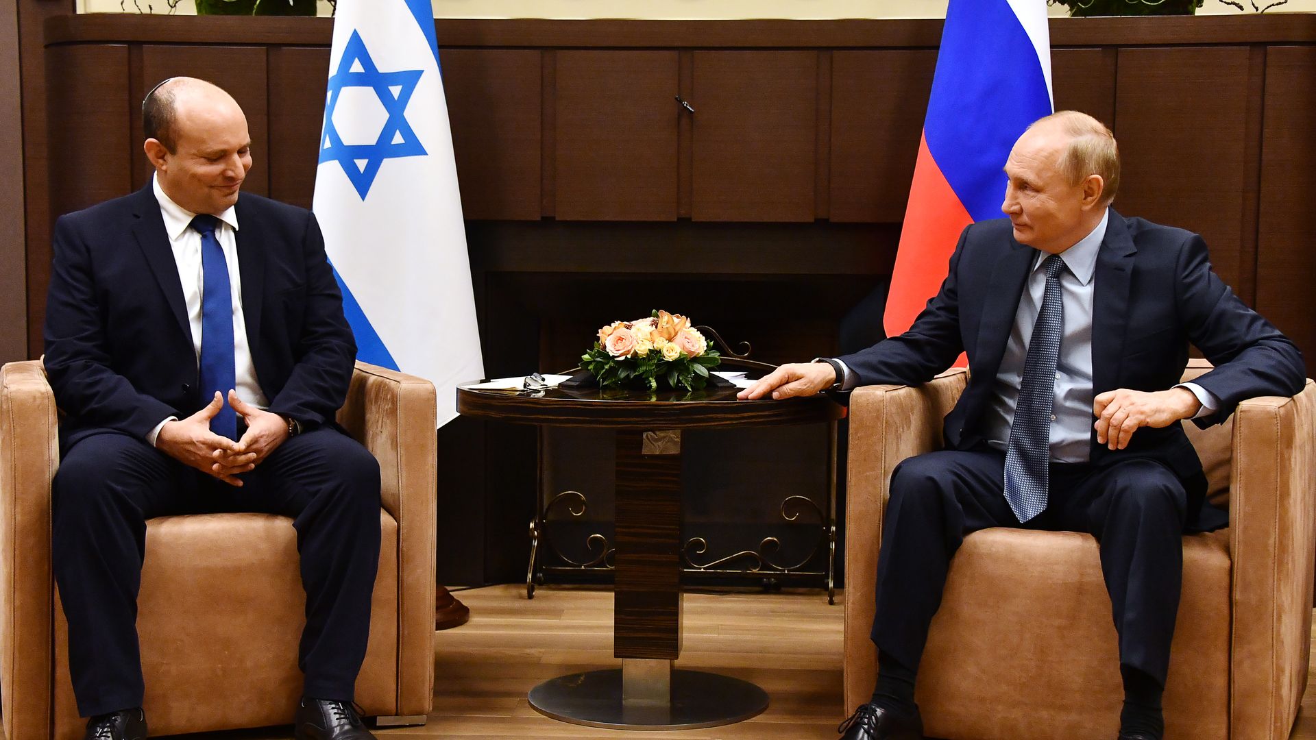 Israels Prime Minister Naftali Bennett (L) and Russias President Vladimir Putin talk during a meeting in Sochi in Oct. 2022