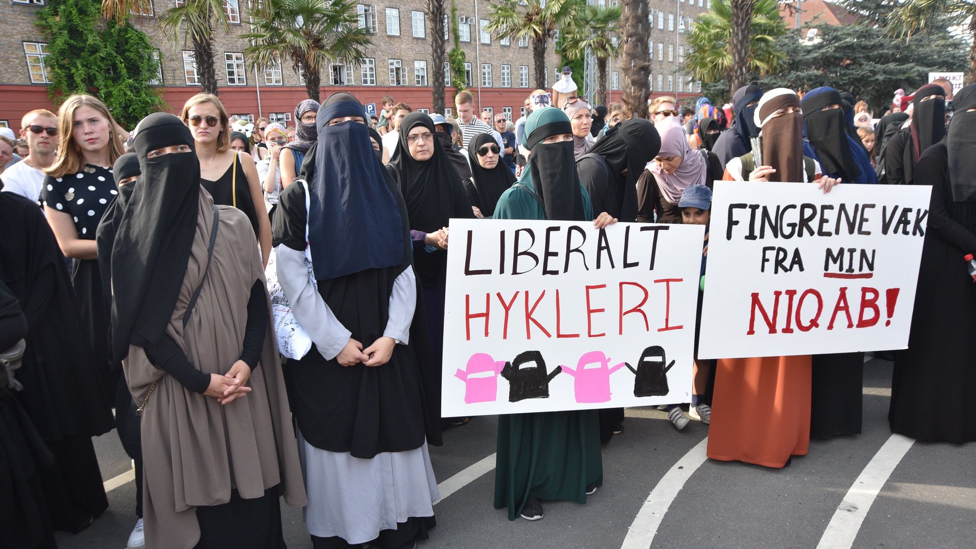 Veiled protestors hold signs in Copenhagen