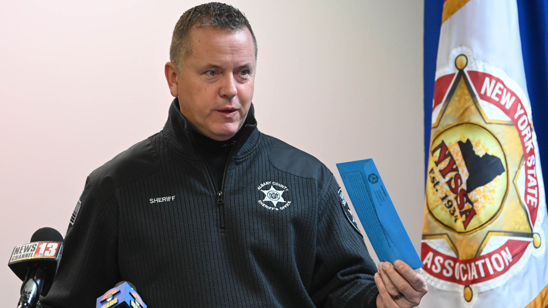 photo of Albany County Sheriff with blue envelope