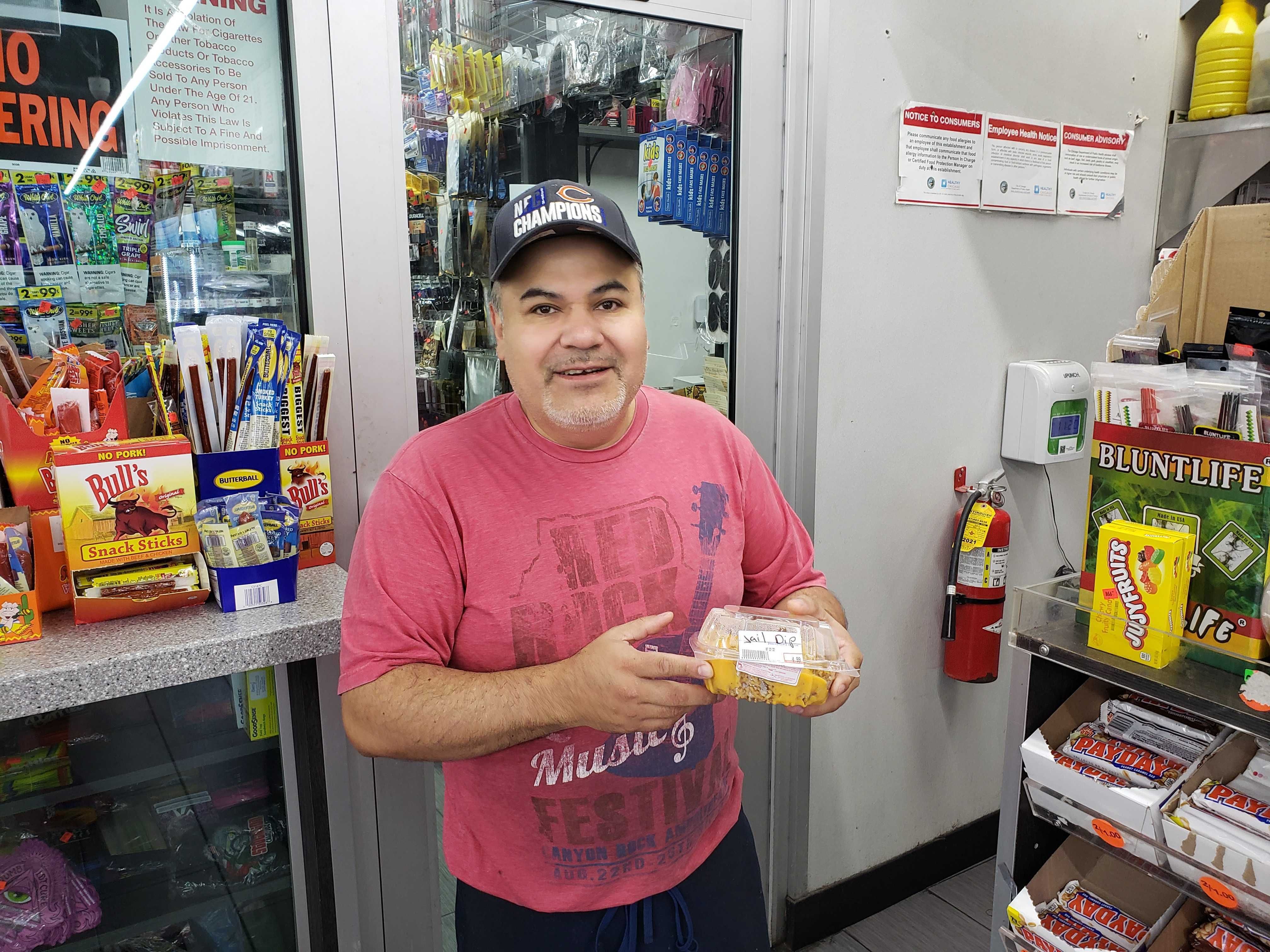Photo of a man holding dip from a store. 