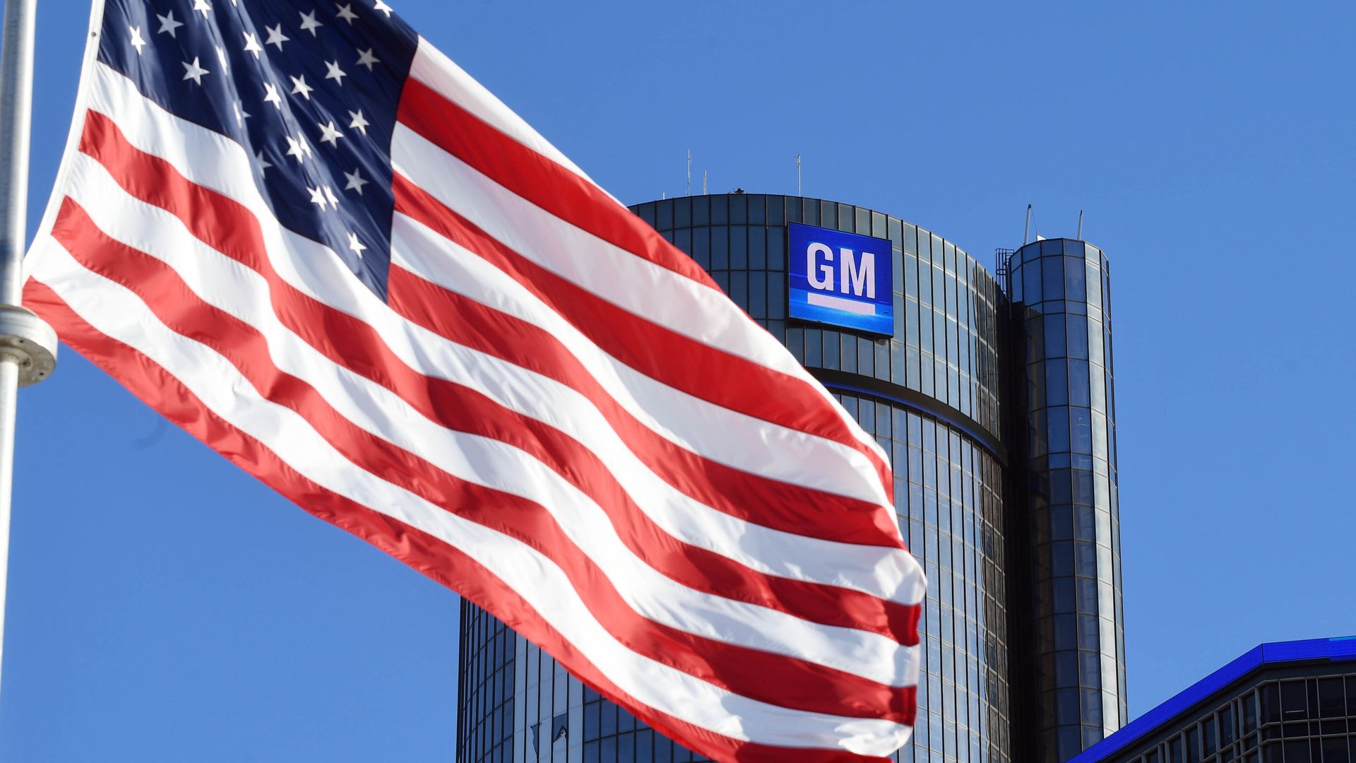 Image of GM headquarters with American flag flying in front