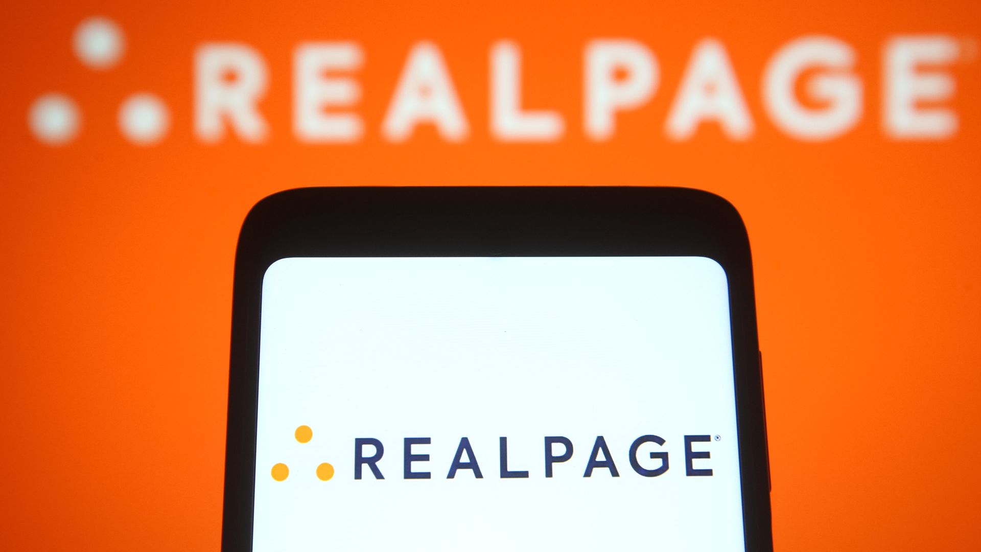 A photo illustration of a cell phone with the company logo for REALPAGE