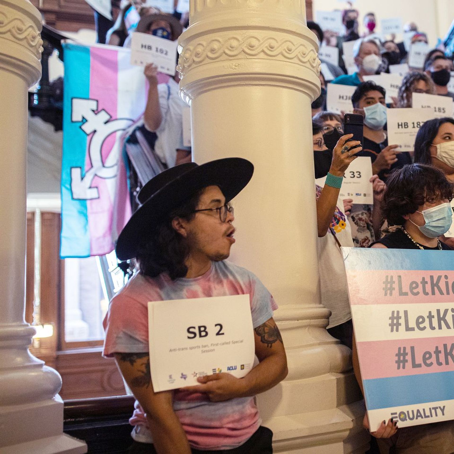 A photo of LGBTQ+ rights activists at the Texas capitol