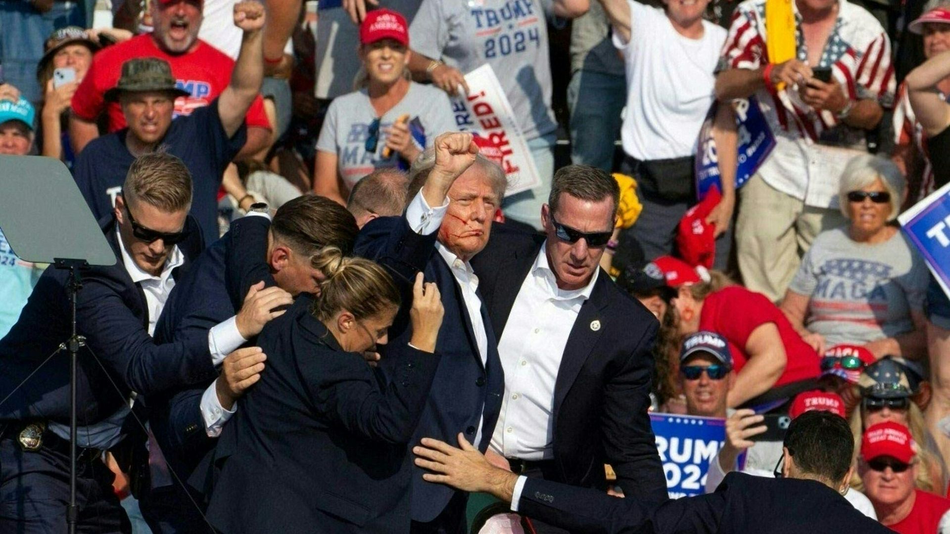Republican candidate Donald Trump is seen with blood on his face surrounded by secret service agents as he is taken off the stage at a campaign event at Butler Farm Show Inc. in Butler, Pennsylvania, July 13, 2024.